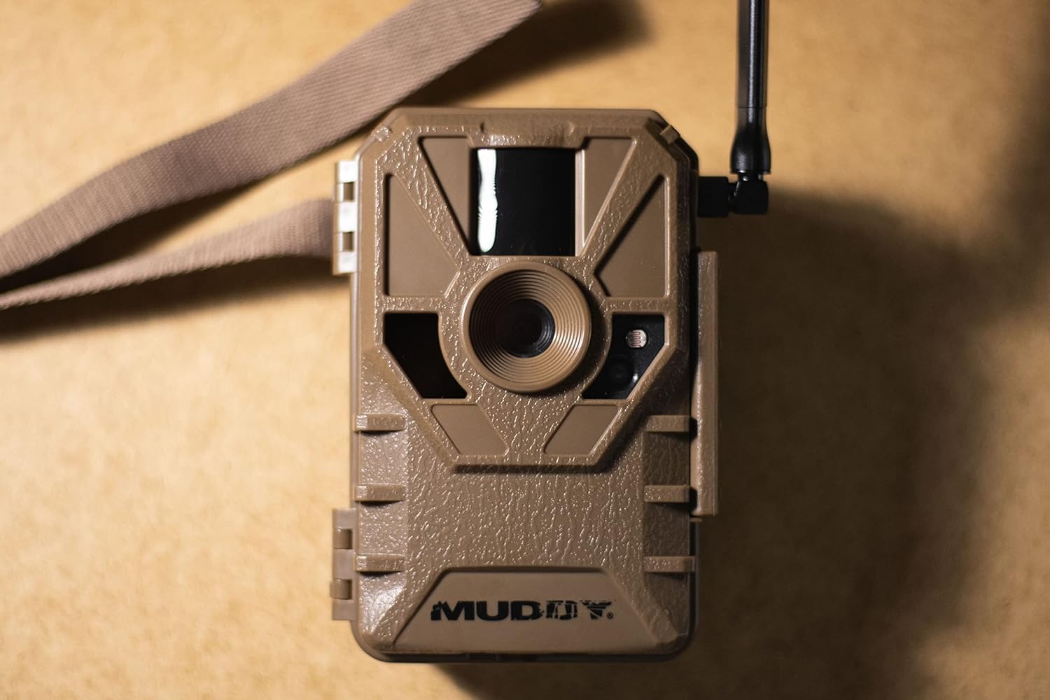 Close-up of the Muddy Manifest 2.0 Cellular Trail Camera's front panel, showing lens and sensors