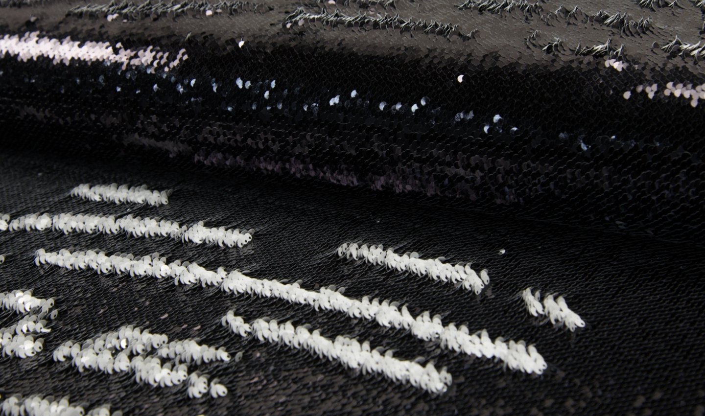 Tissu paillettes deux tons sirène blanc noir pour robe de cocktail