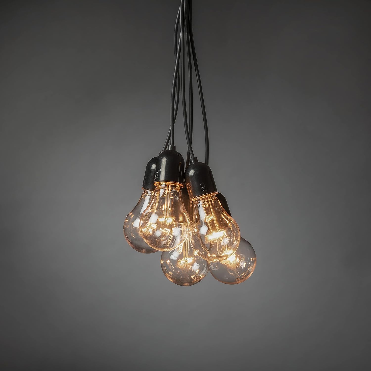 Close-up of Konstsmide LED bulbs with black cables.