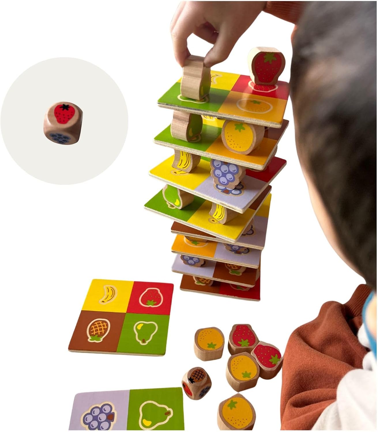 A child demonstrating stacking individual wooden fruit pieces into a tall, balanced column.