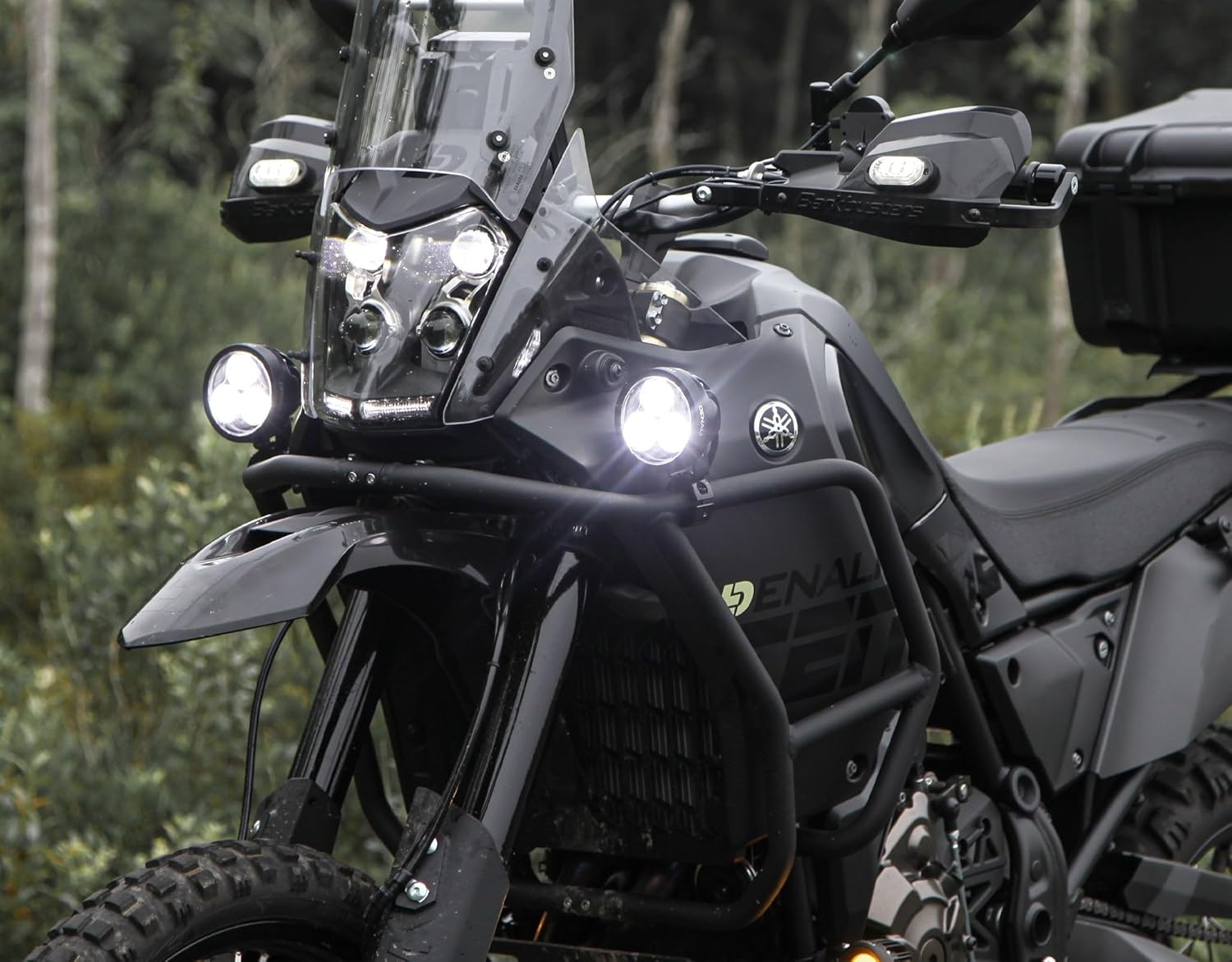 DENALI D3 LED Driving Light Pods installed on a motorcycle, emitting bright white light.