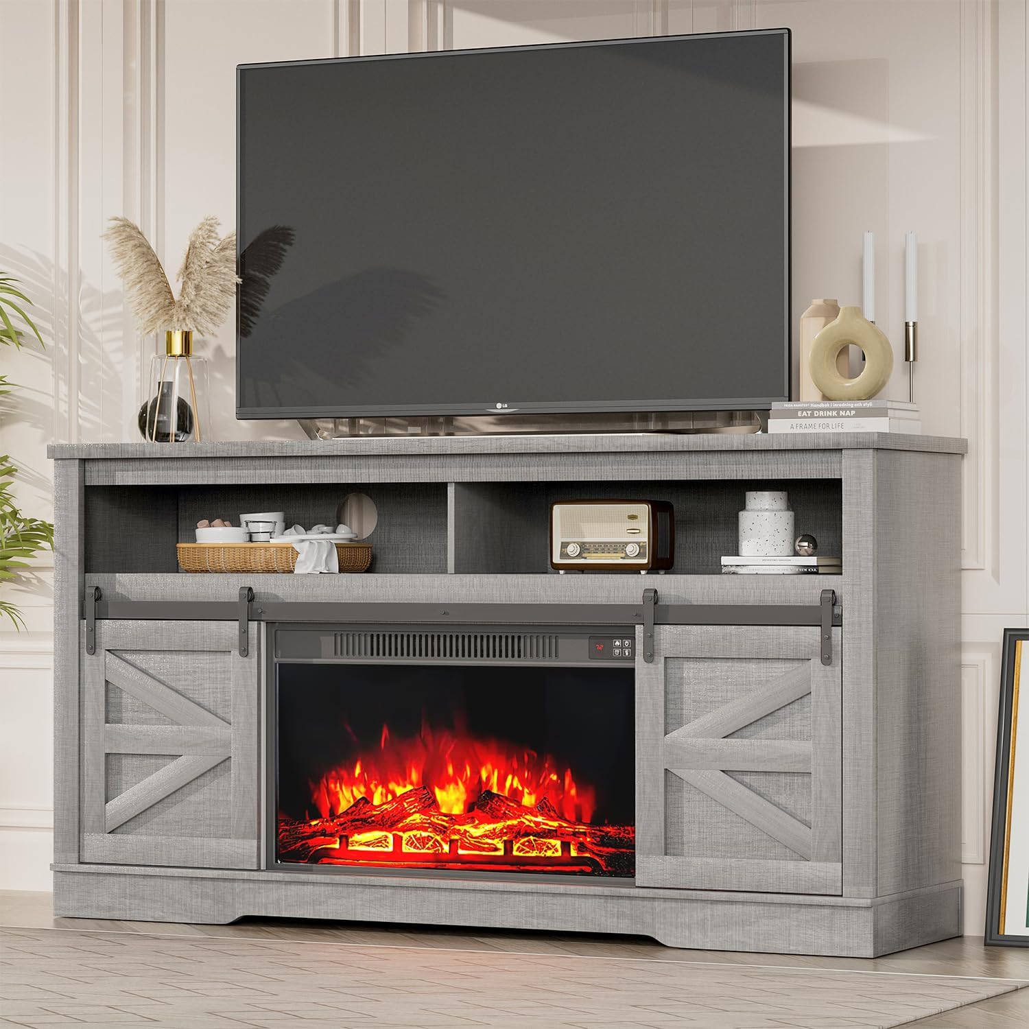 Front view of the YESHOMY Fireplace TV Stand with a television on top and the electric fireplace glowing.