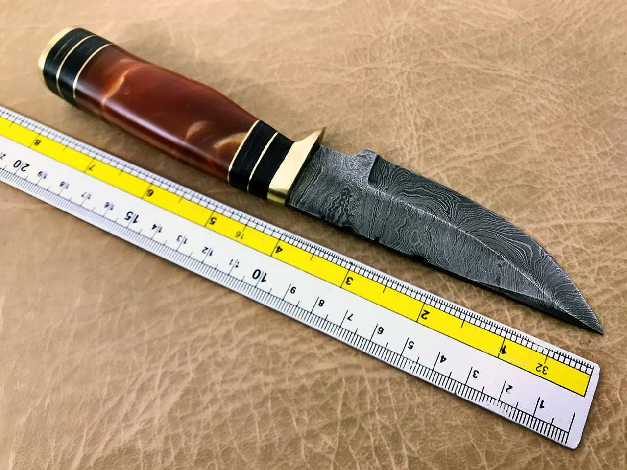 8 inches long Damascus steel fixed blade skinning knife with Leather sheath, Cognac color scale made of unshrinkable Raisen, round scale with brass finger guard and cap,