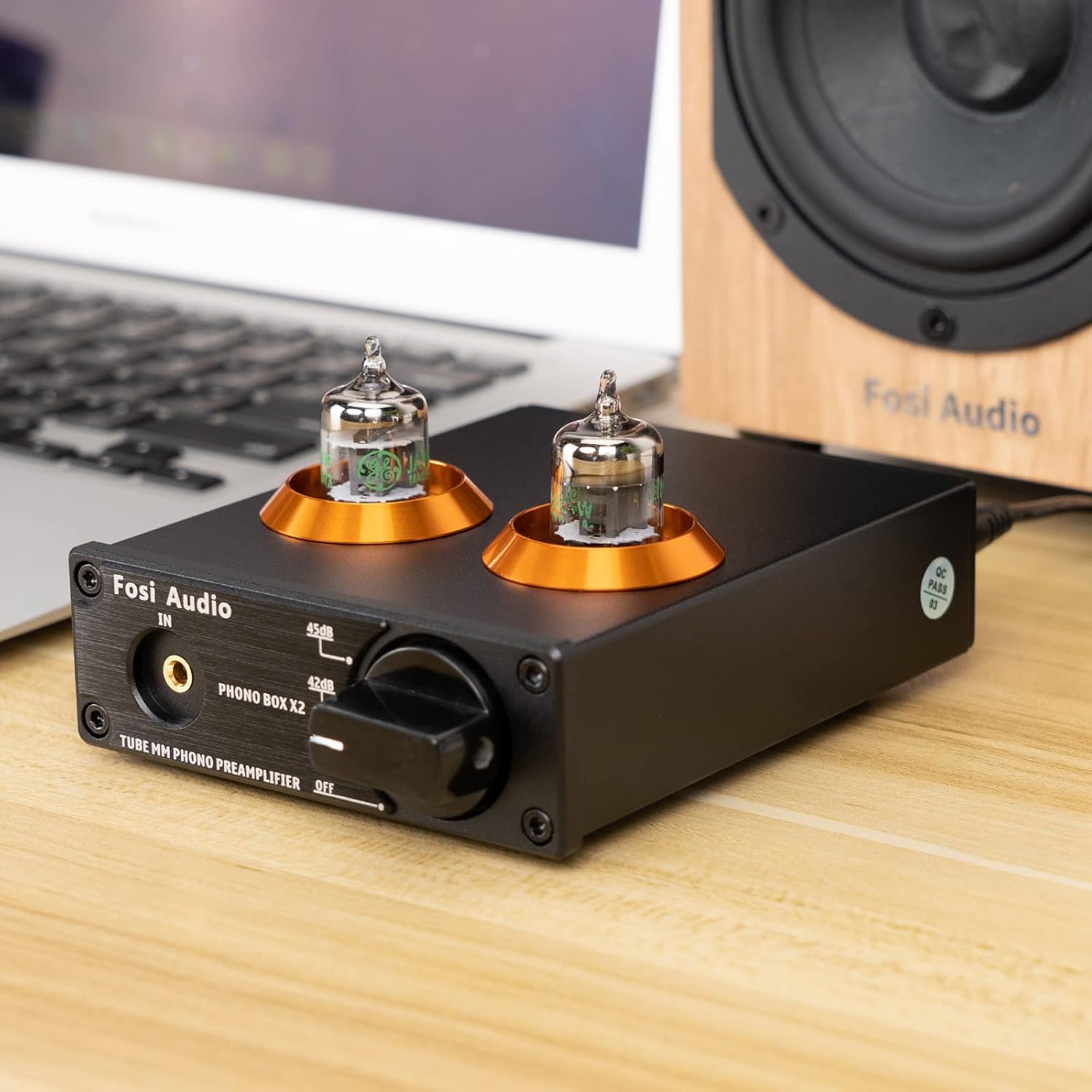 Fosi Audio BOX X2 preamplifier with 5654W tubes installed, next to a laptop and speaker.