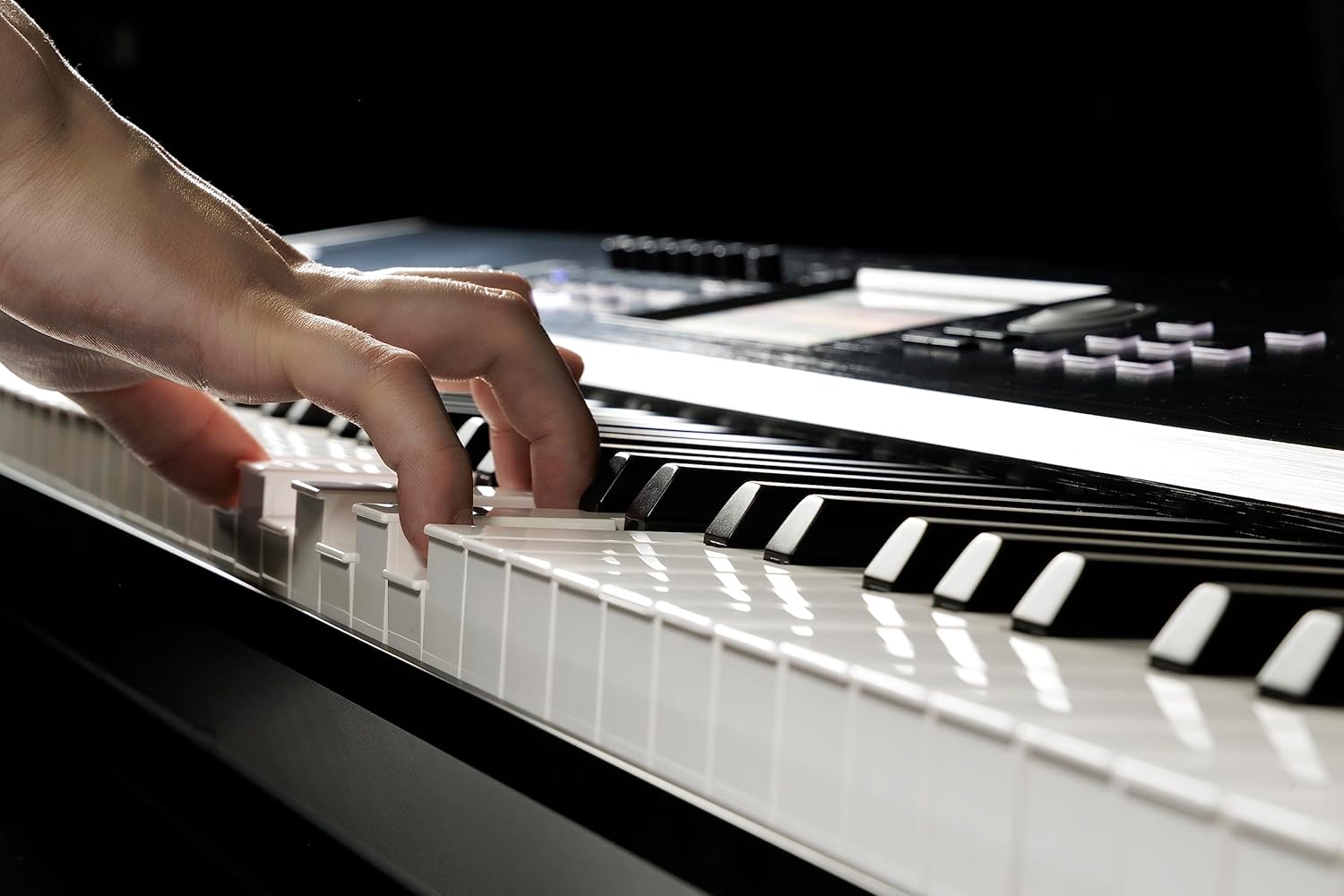 Hands playing the Korg NAUTILUS88AT keyboard