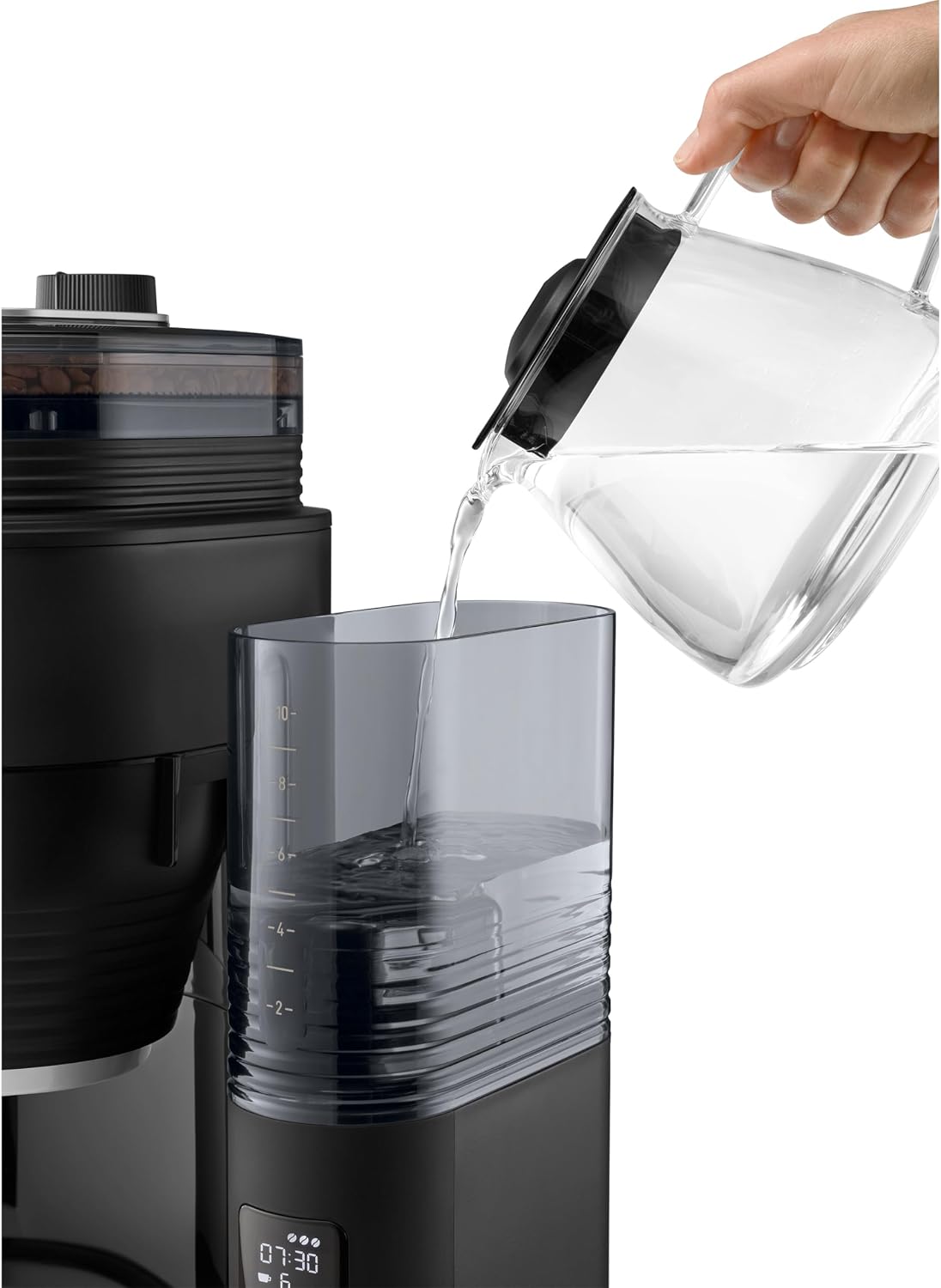 Hand pouring water into the Melitta AromaFresh X water tank
