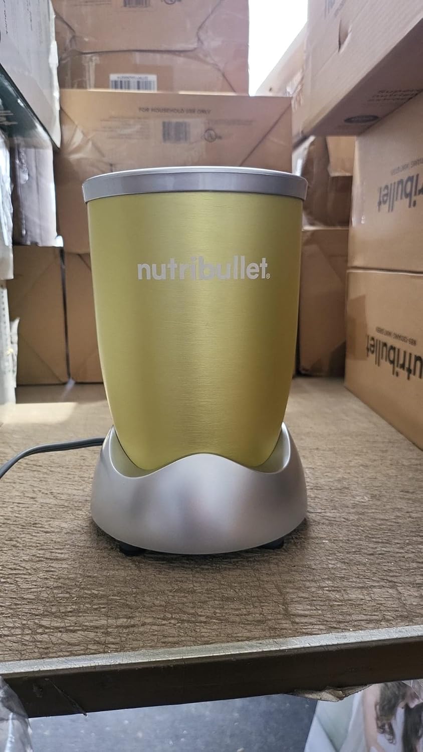 NutriBullet Pro 900 Watt Blender motor base on a wooden surface.