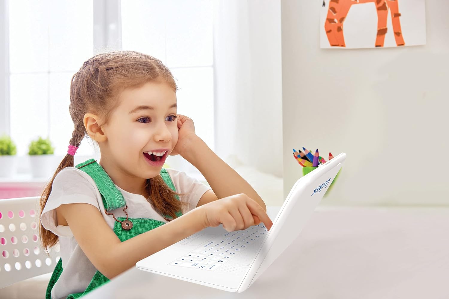 Young girl happily using the LEXiBOOK JC598i13 laptop