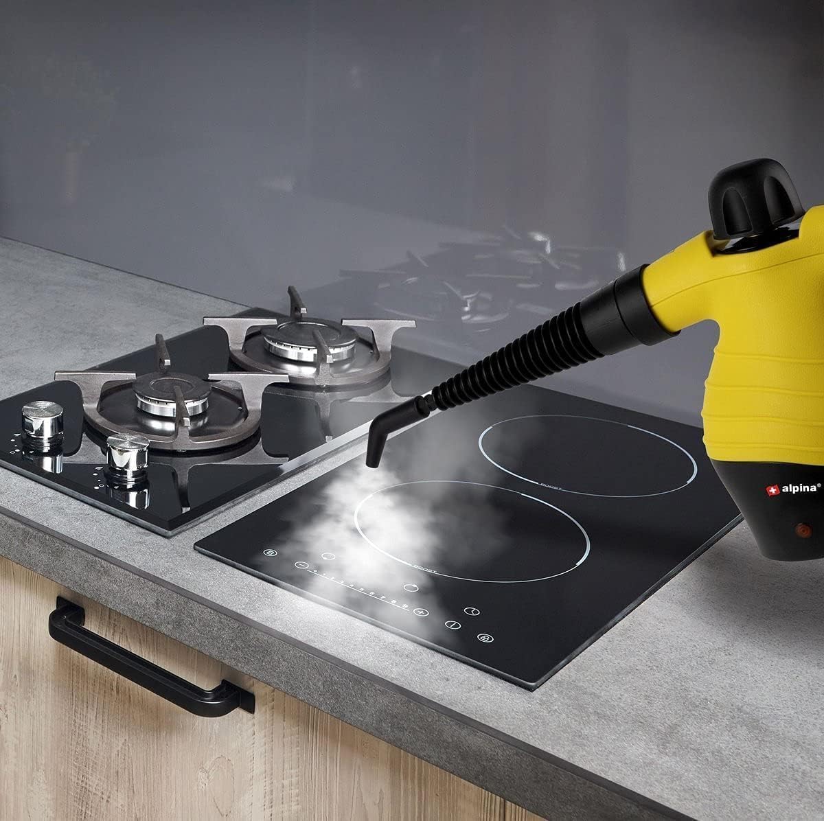Steam cleaner being used to clean a kitchen stovetop