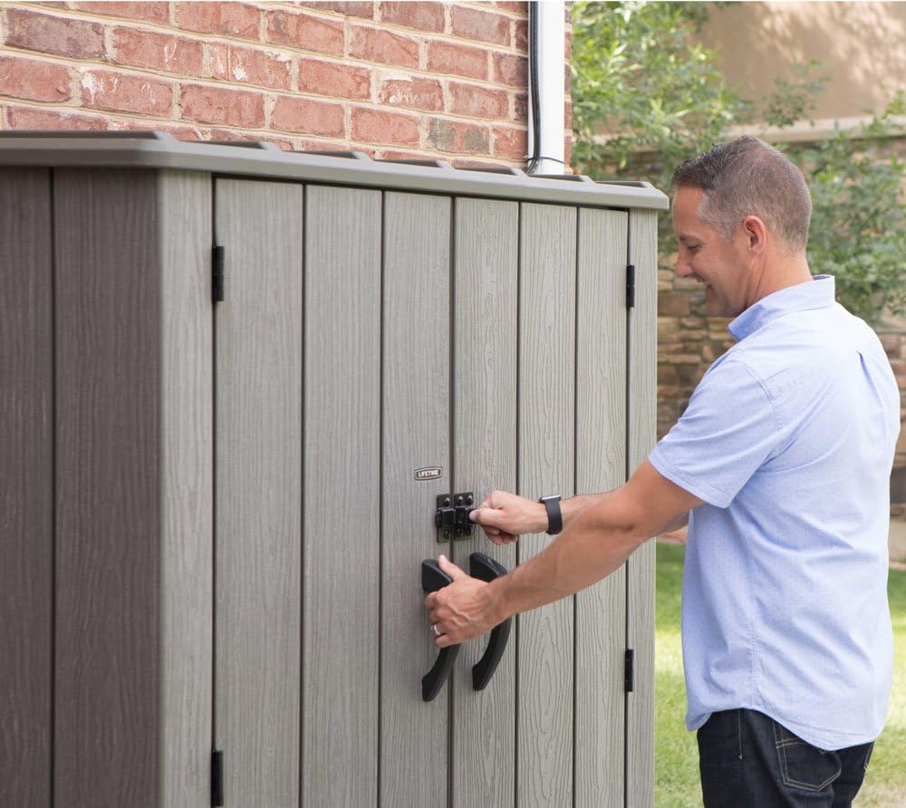 Adult securing the shed with a padlock