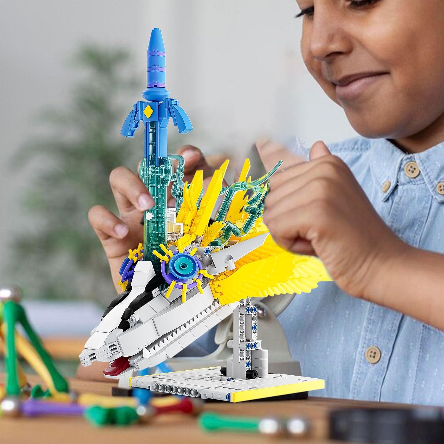 A child's hands assembling parts of the Light Dragon's head from the building set, with the instruction manual visible.