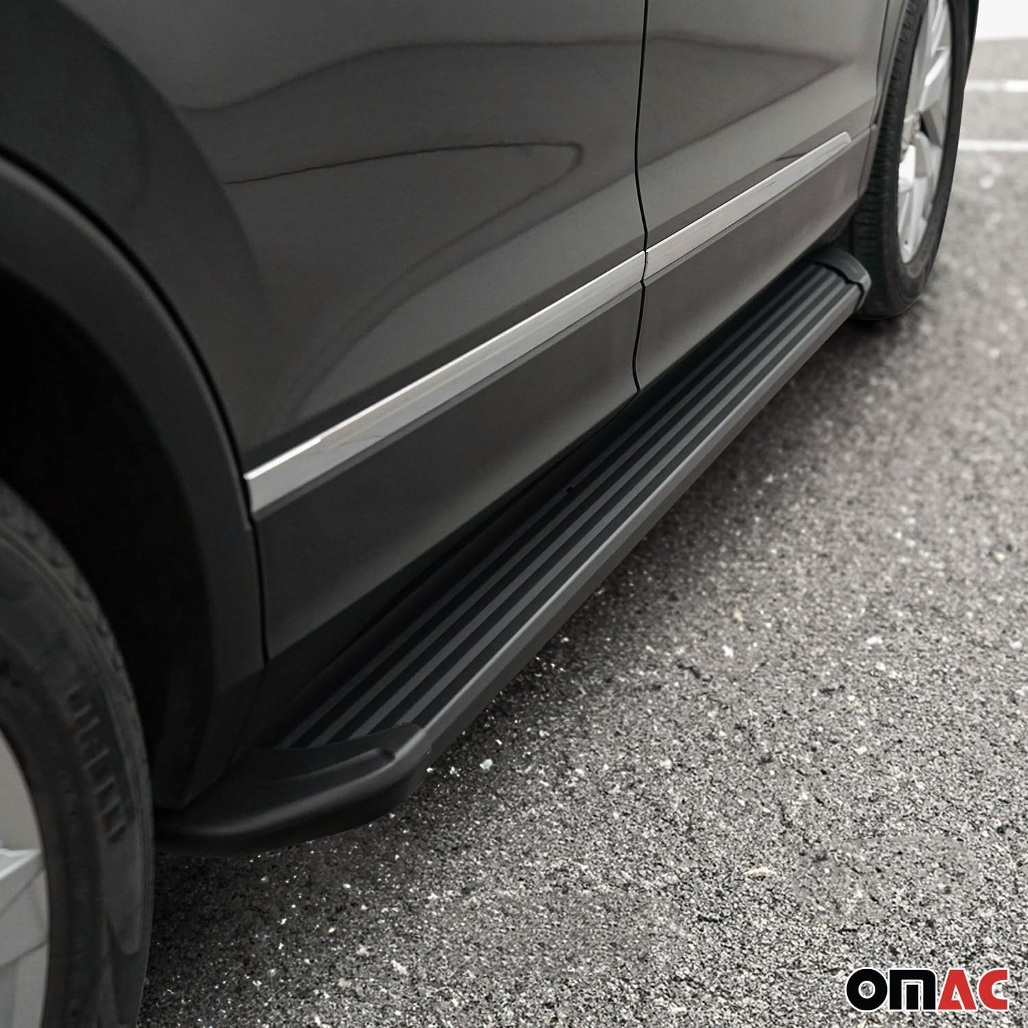 OMAC Side Step installed on a dark grey vehicle, showing its integration with the vehicle's design.