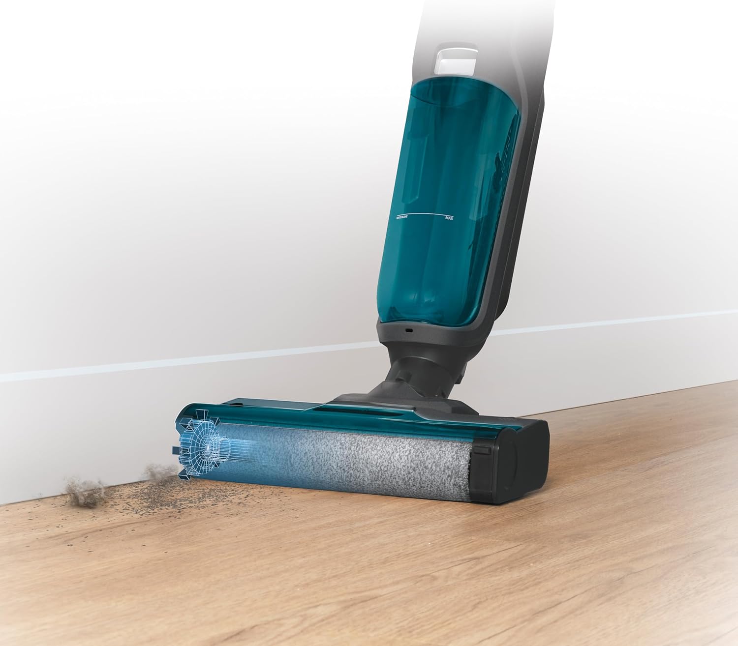 Close-up of the vacuum cleaner's brush head cleaning along a baseboard, showing dirt being collected