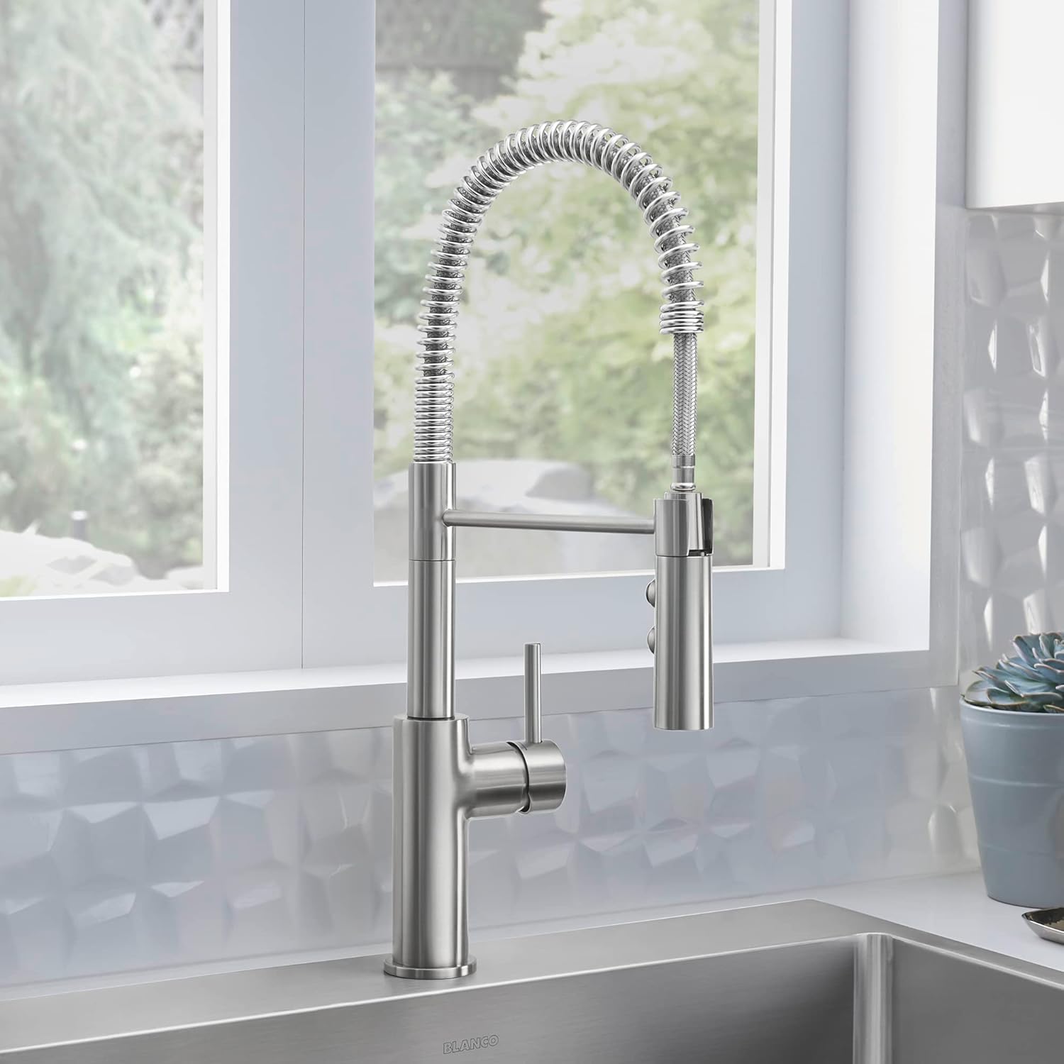 BLANCO CATRIS Semi-Pro Kitchen Faucet installed in a modern kitchen with a window in the background.