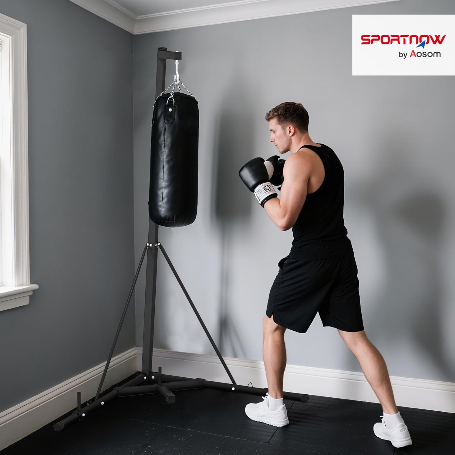 Image of a person using the SPORTNOW punching bag stand with a heavy bag attached, demonstrating proper setup.