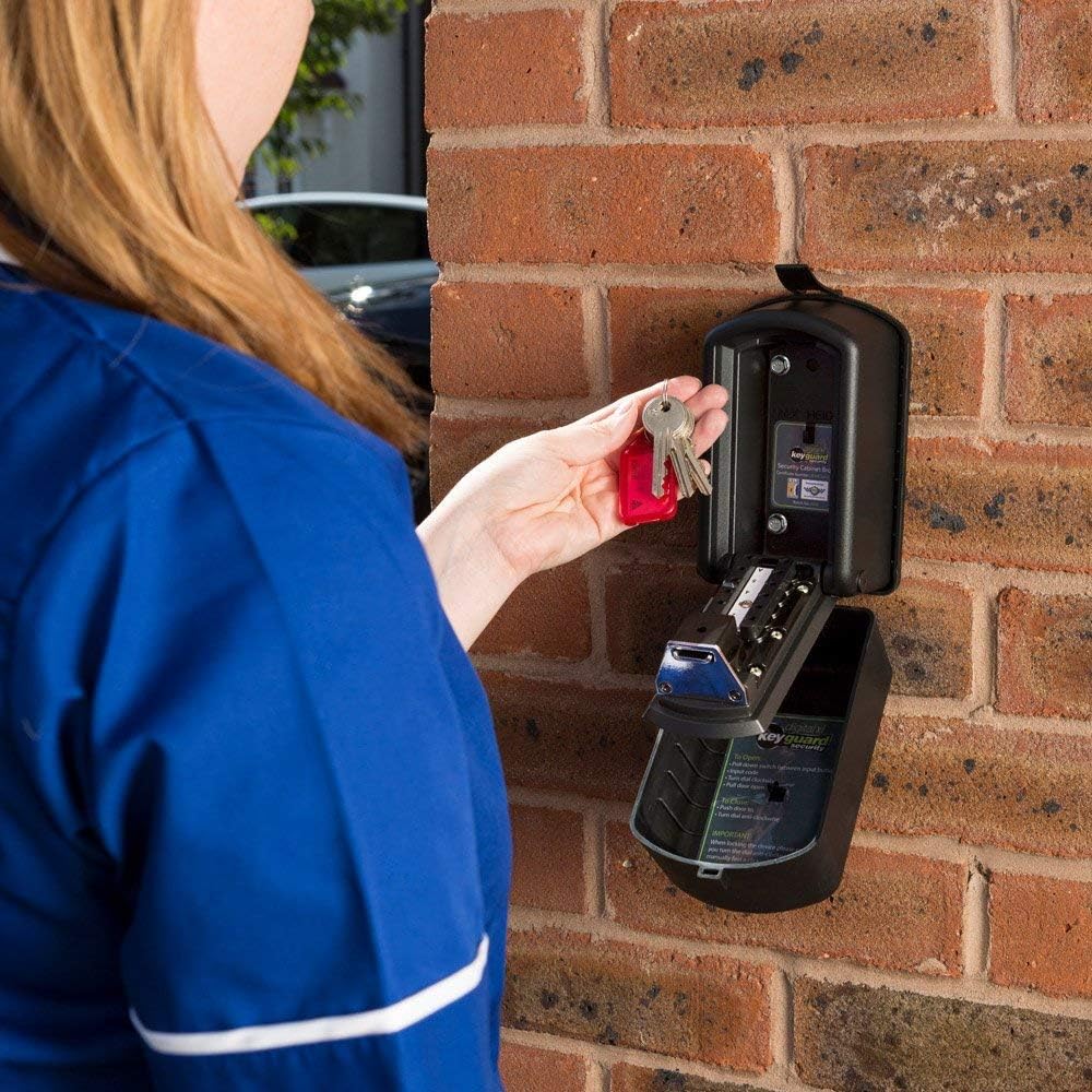 User placing a key into the mounted Burton Safes Keyguard XL