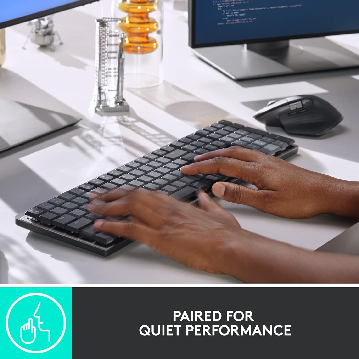 Hands typing on the MX Mechanical Keyboard, with the MX Master 3S Mouse nearby, indicating quiet performance