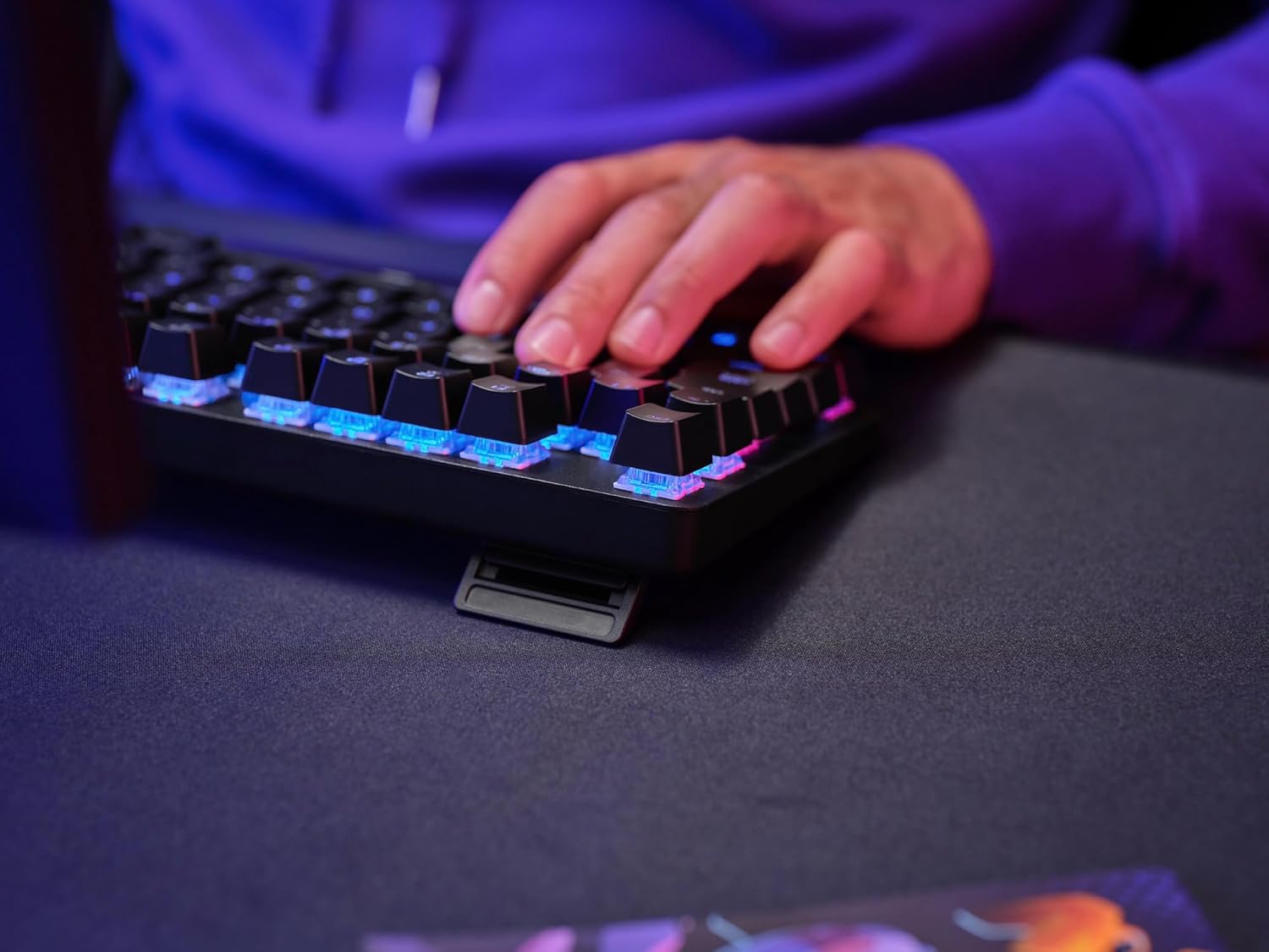 Close-up view of the adjustable feet on the underside of the Trust Gaming GXT 871 Zora keyboard, showing its three-step height adjustment.