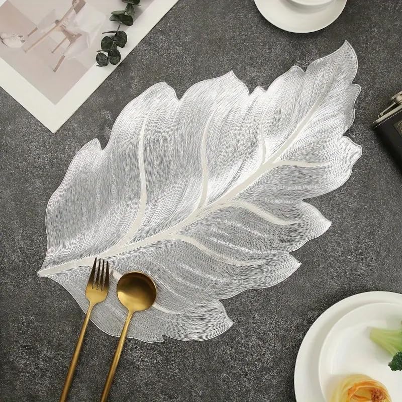 Image of Dakshya Industries Set of 2 PVC Waterproof Leaf Design Table Placemats | Premium Gold Finish Dining Table Mats | Heat Resistant, Washable & Anti-Slip | Decorative Kitchen & Dining Mats (Silver)