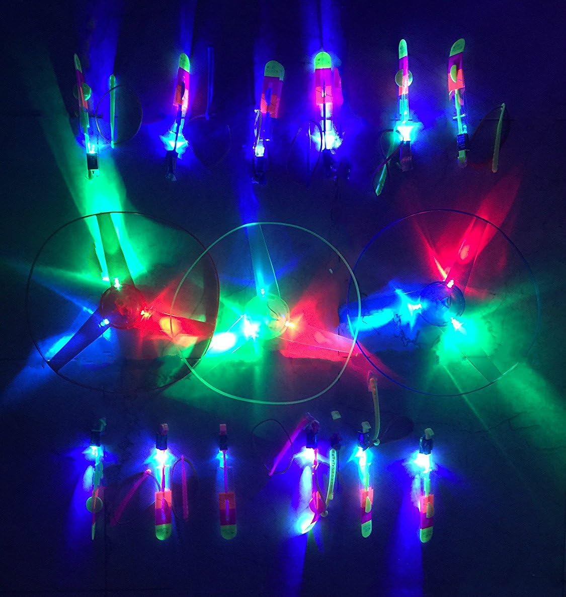 30 Pieces Flying LED Light Up Toy Party Pack - 12 Pcs Changing Color Led Light Arrow Rocket copters +15 Pcs Light Up Flying Sling shot Arrow Rocket + 3Pcs Light Up Flying Saucer UFO With Hand Launcher