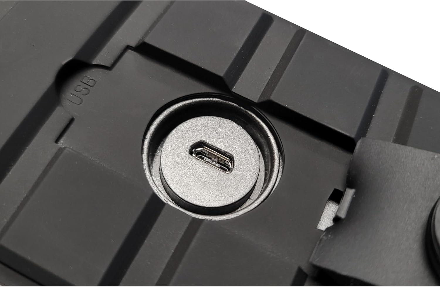Close-up of the USB charging port on the Supersonic SC-1455IPX speaker, located under a waterproof flap.