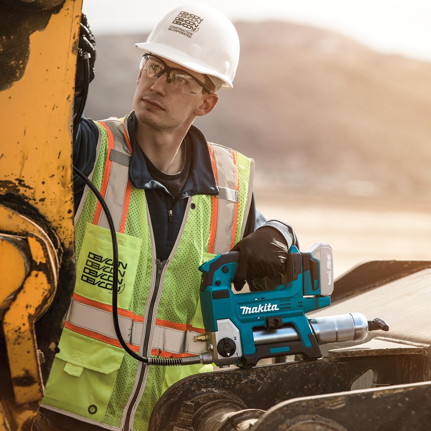 User greasing heavy equipment with Makita DGP180Z