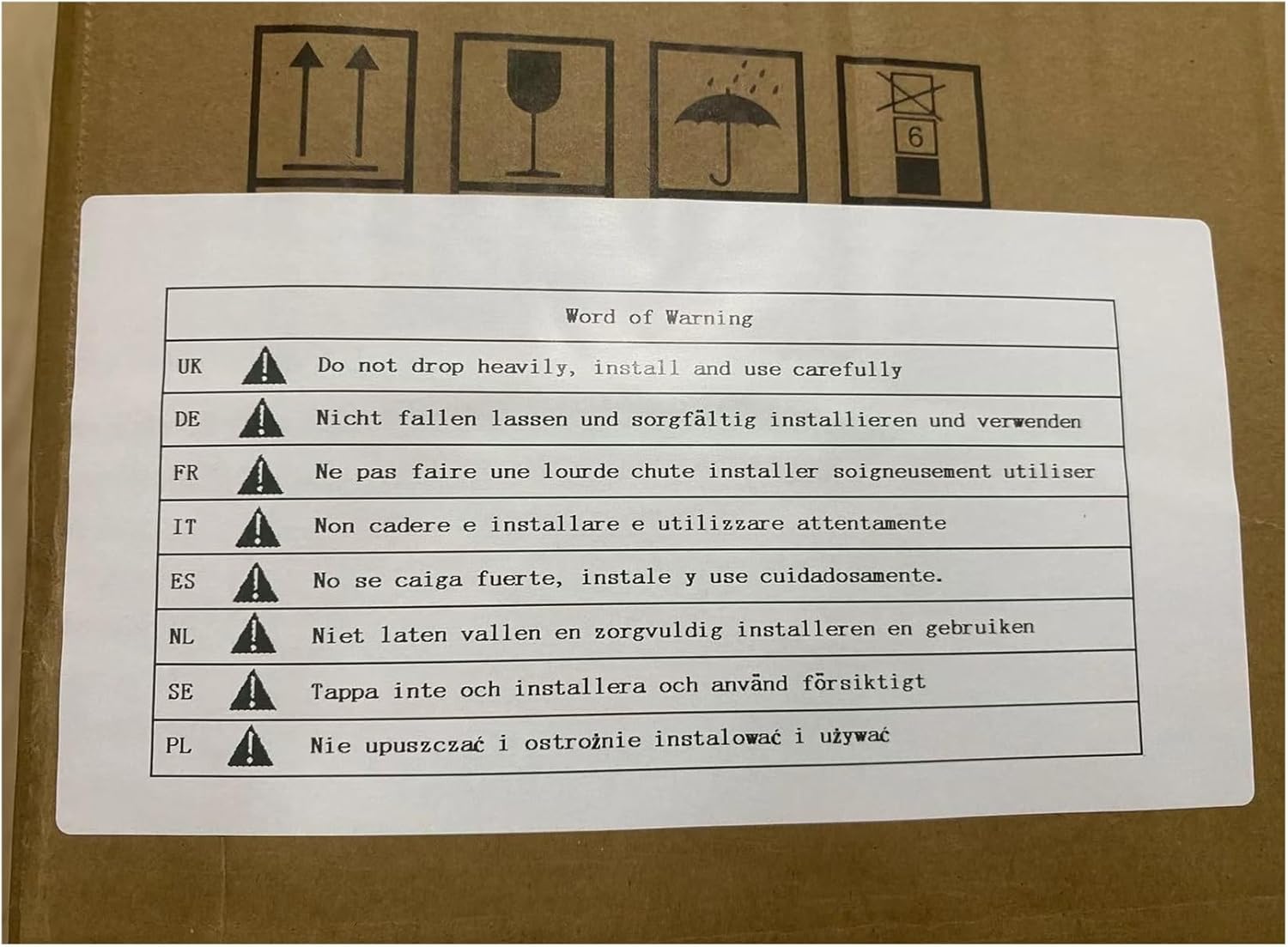 Warning label on packaging with text 'Do not drop heavily, install and use carefully' in multiple languages