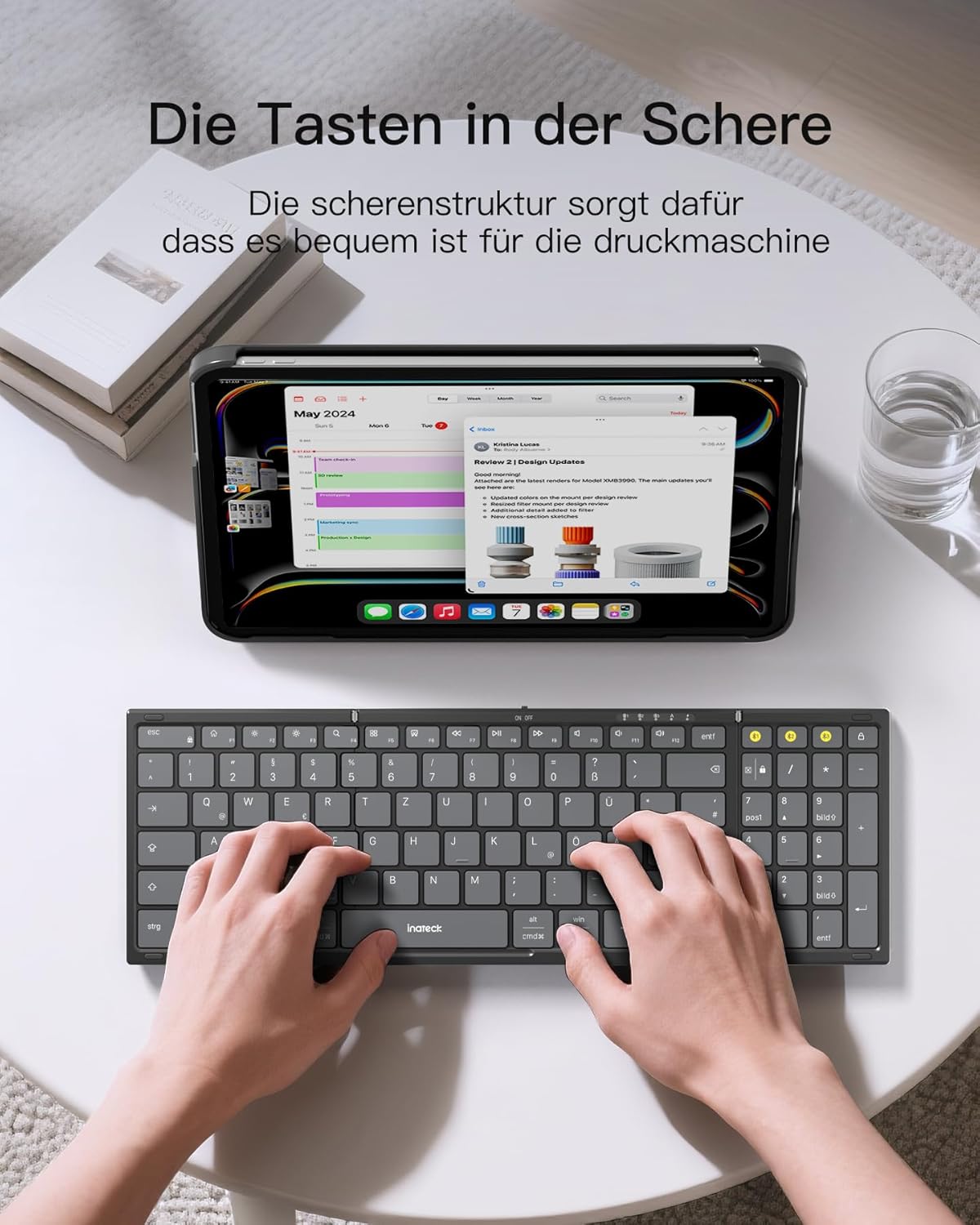 User typing on the Inateck Nomad N0158 foldable keyboard with a tablet on a stand.