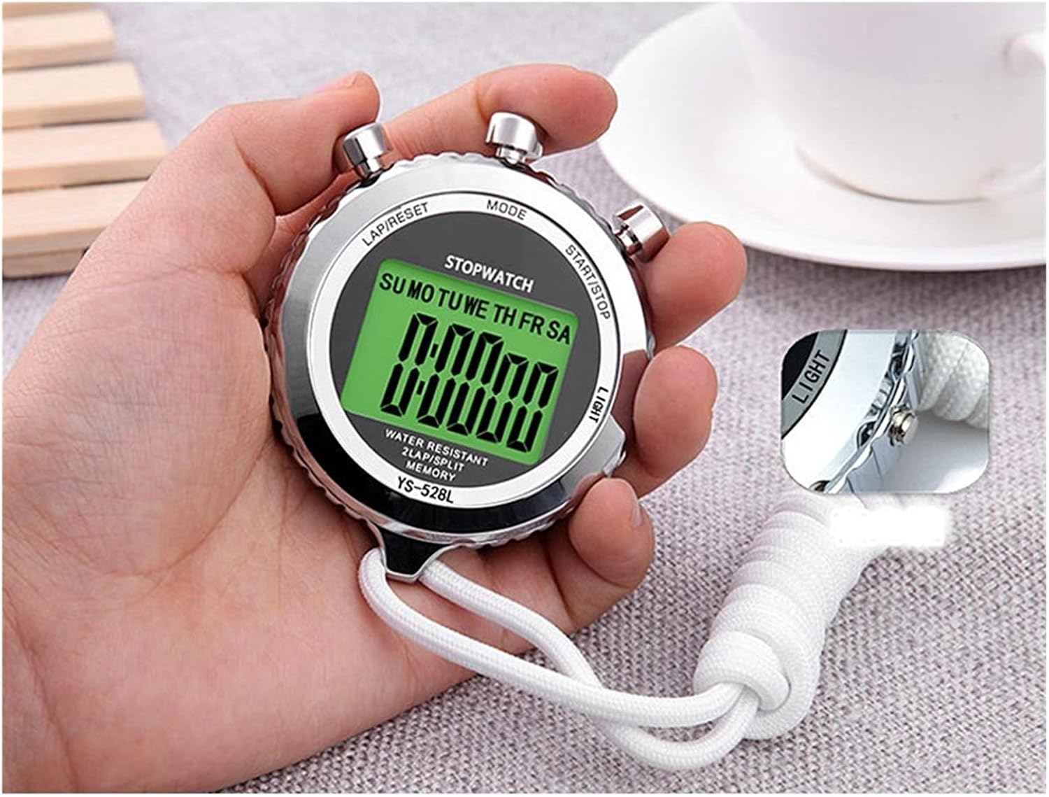 Hand holding LIBODD YS-528L Stopwatch, showing button layout