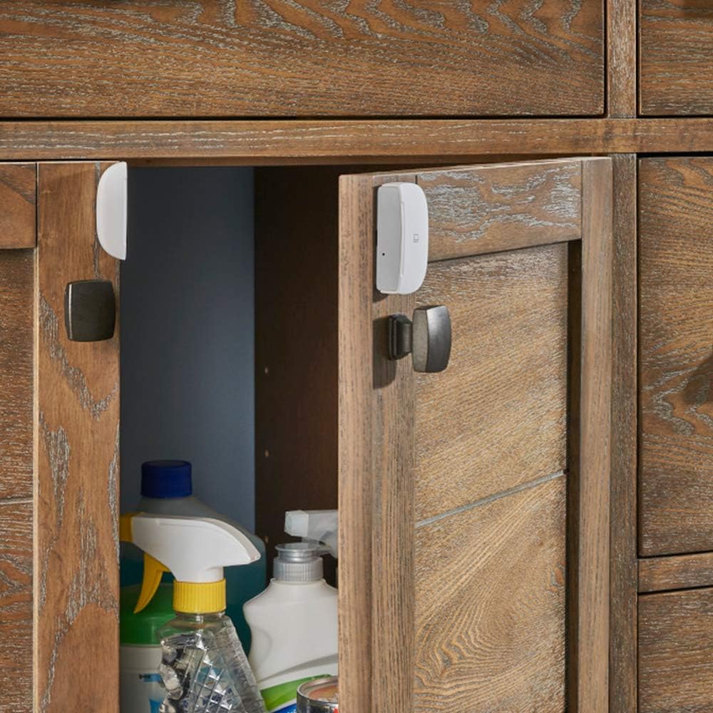 Samsung SmartThings Multipurpose Sensor installed on a cabinet door.