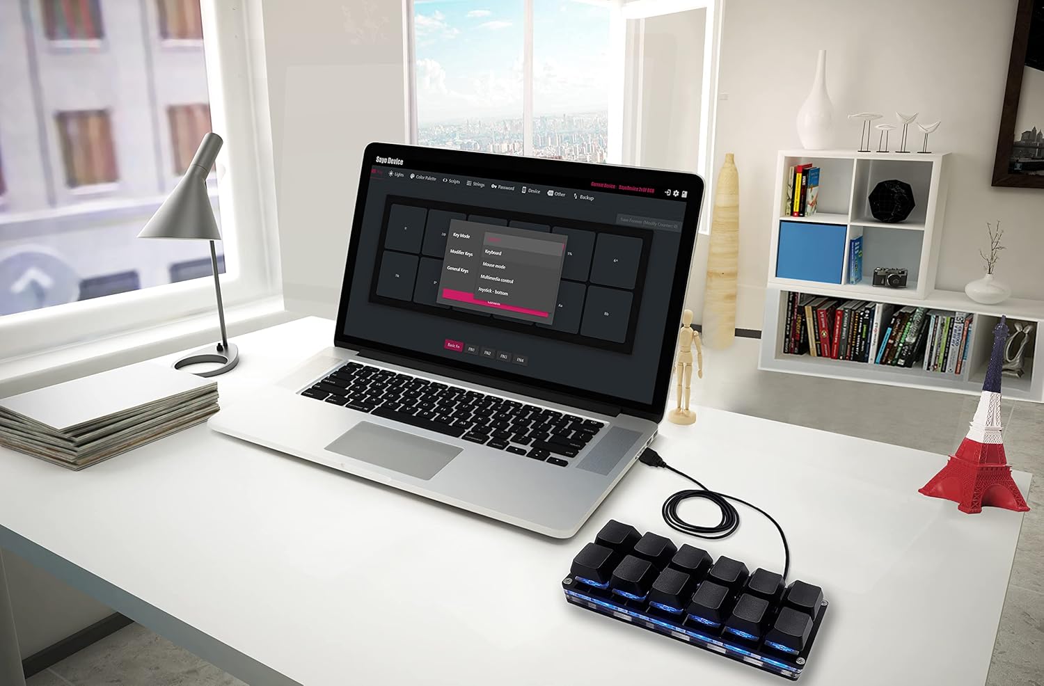 A laptop displaying the SayoDevice web interface for keyboard configuration, showing options for key mapping and settings.