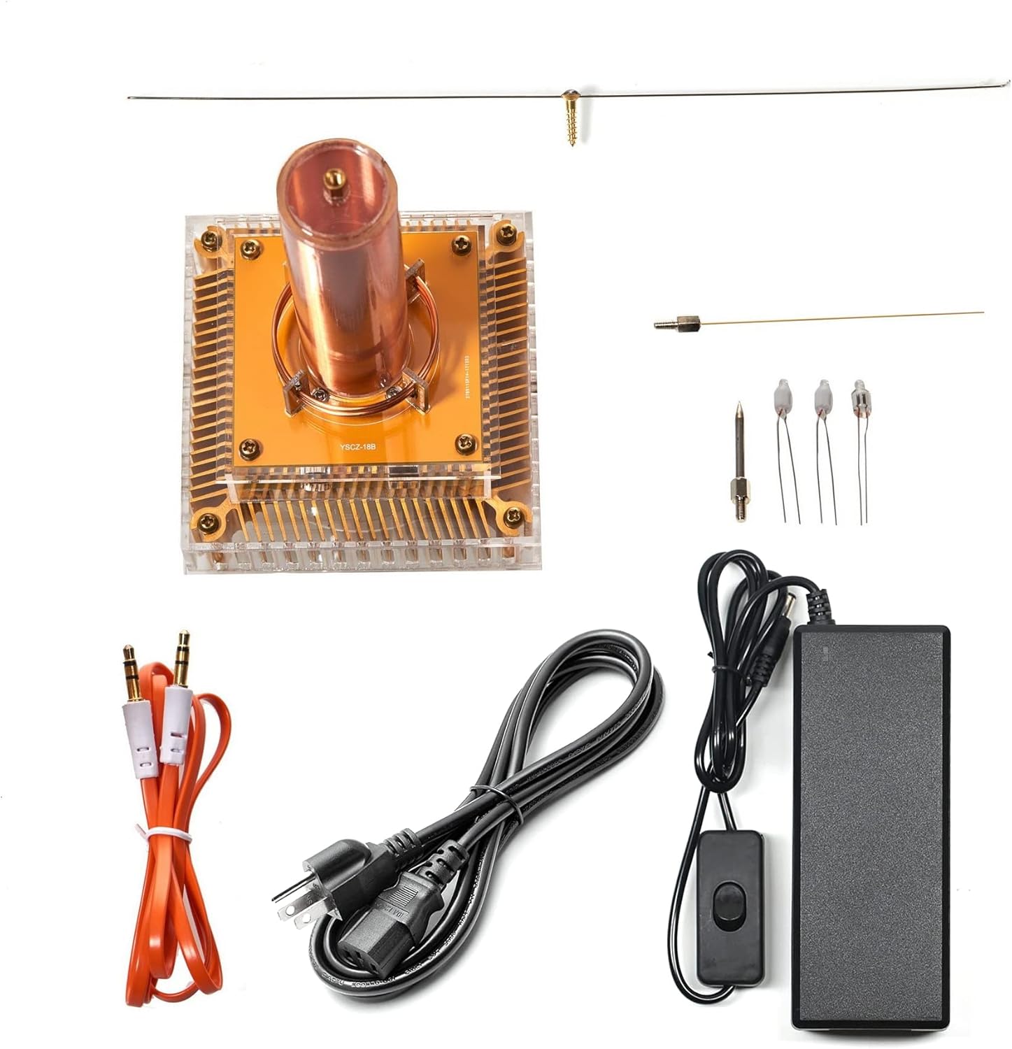 Contents of the Joytech YS04 Music Tesla Coil package, including the main unit, power adapter, audio cable, discharge needle, and various light bulbs.