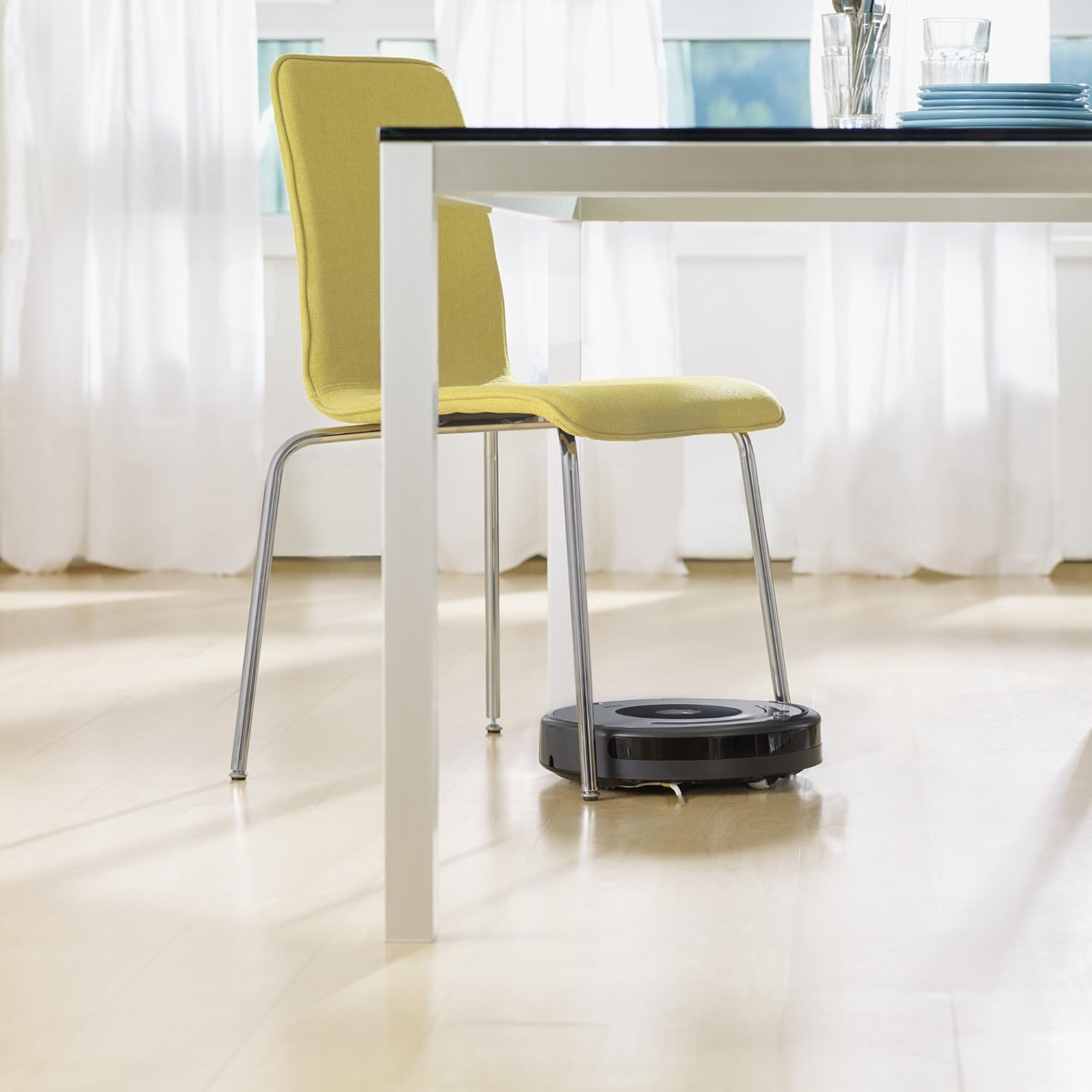 iRobot Roomba 640 cleaning under a dining table