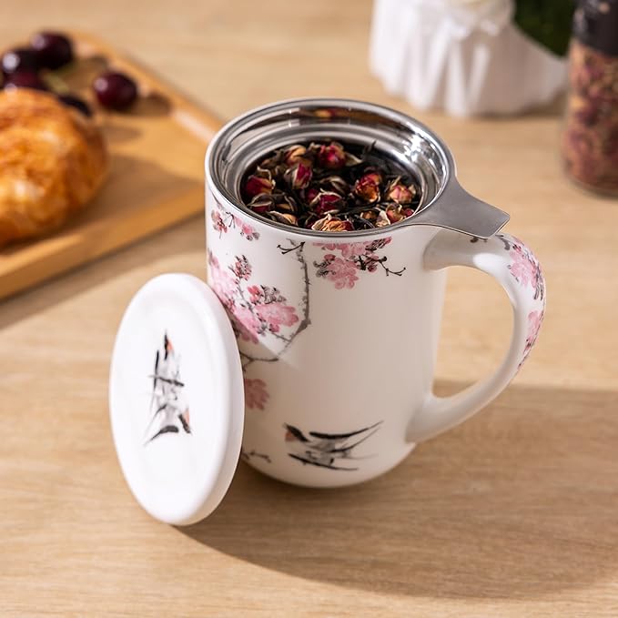 Image of a porcelain tea mug filled with loose tea. The cap is removed to show the inner holder for loose tea.