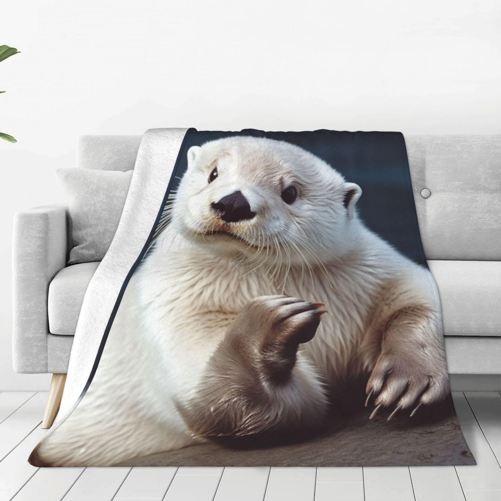 Couverture polaire loutre blanche pour vos soirées cocooning dans le salon