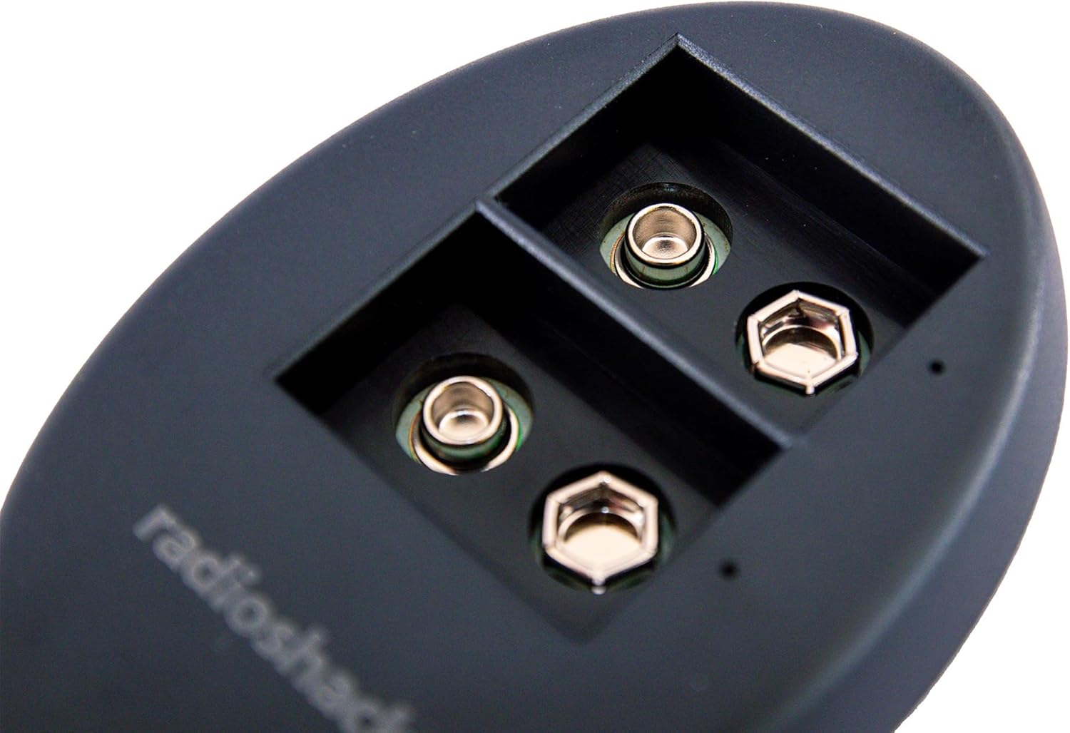 Close-up view of the charging slots on the RadioShack 9V USB Dual Battery Charger, showing the battery terminals.