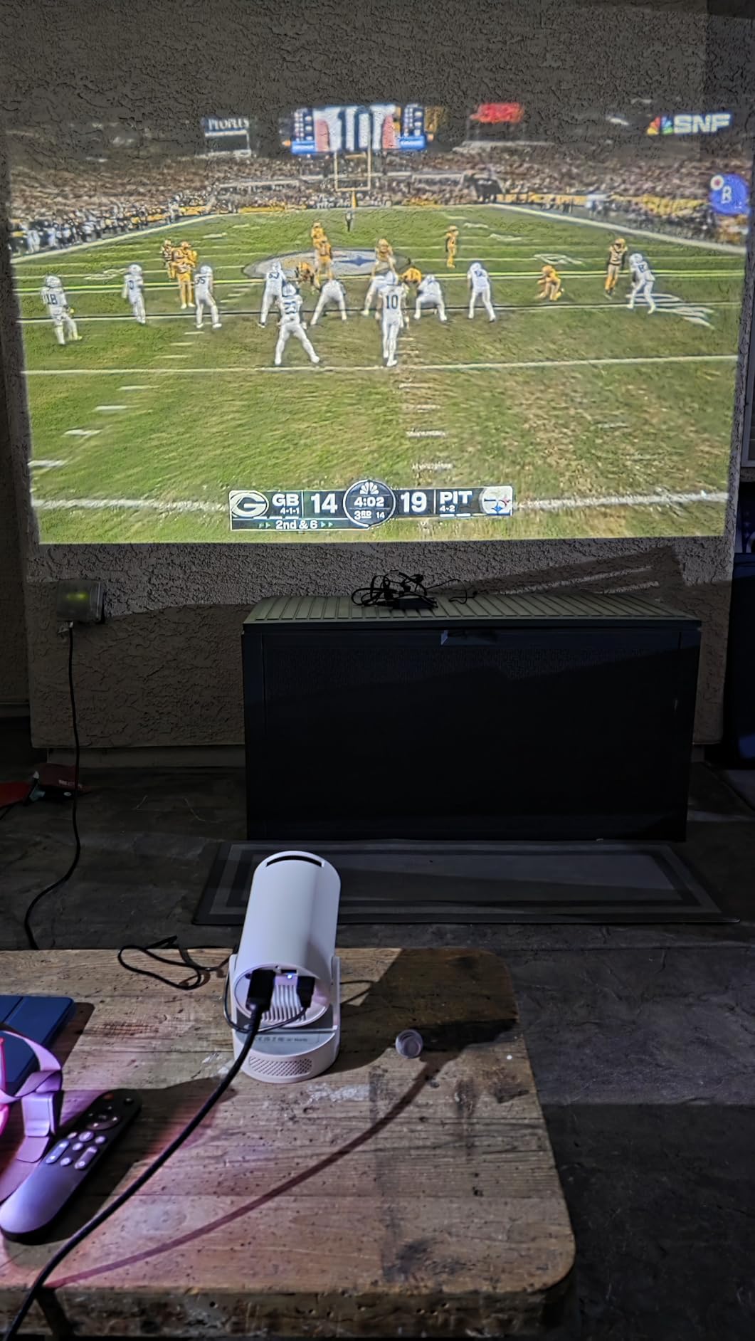 Football match projected on wall