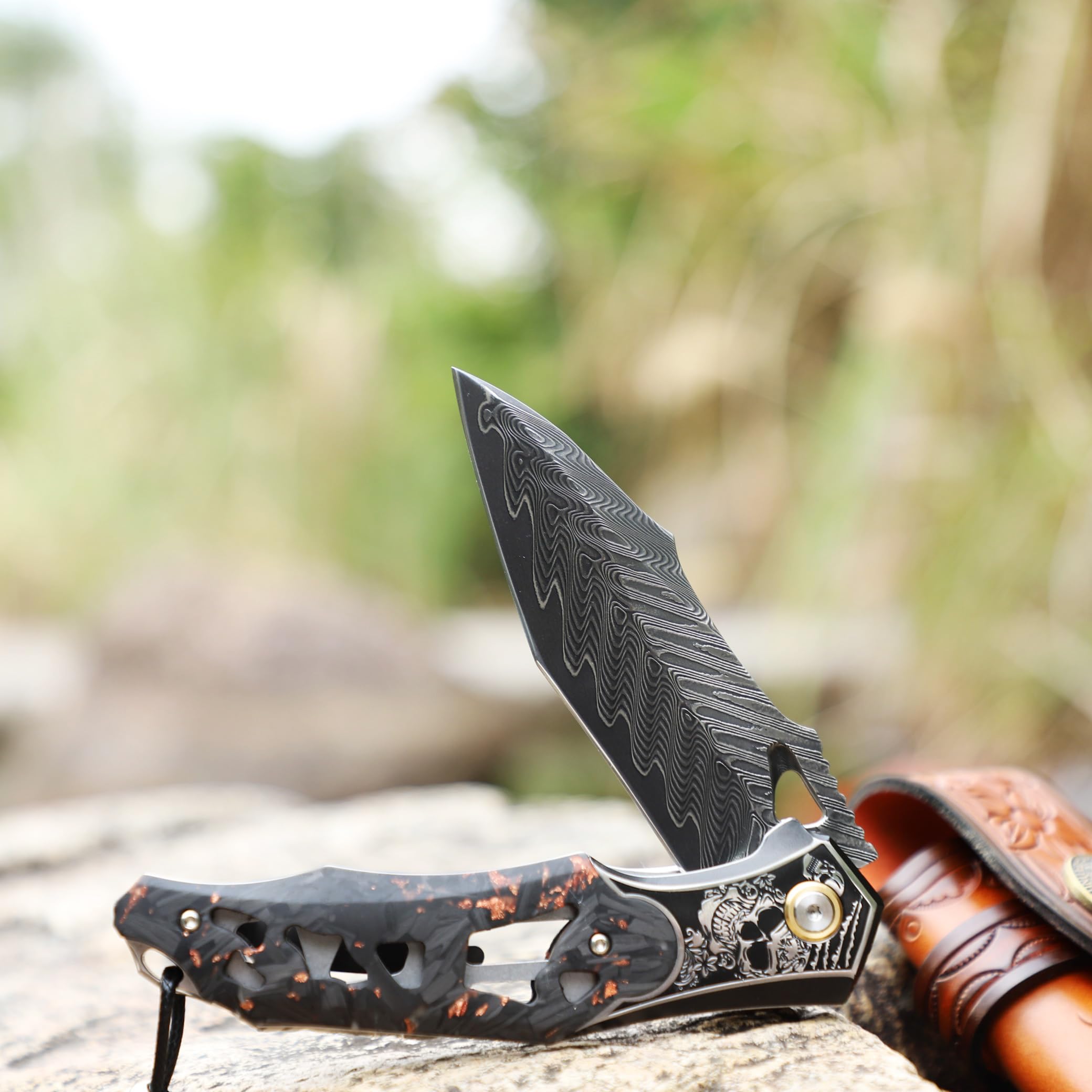 Handmade Men's Folding Pocket Knife, 9" Damascus Steel Folding Knife, Includes a leather sheath, Dazzling Cool Skull pattern, Carbon fiber handle with copper foil integration, Ideal for expedition cam