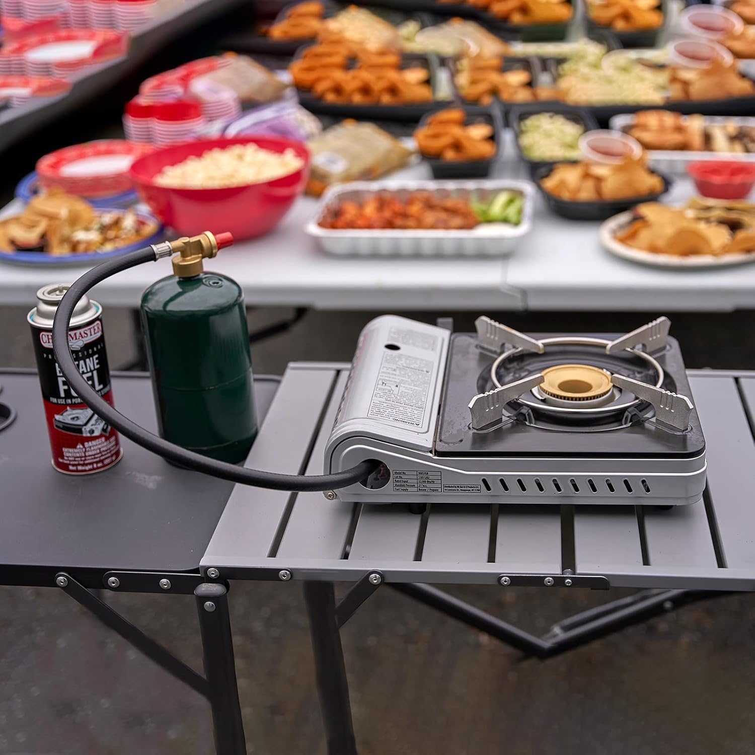 Portable stove in use with a propane tank