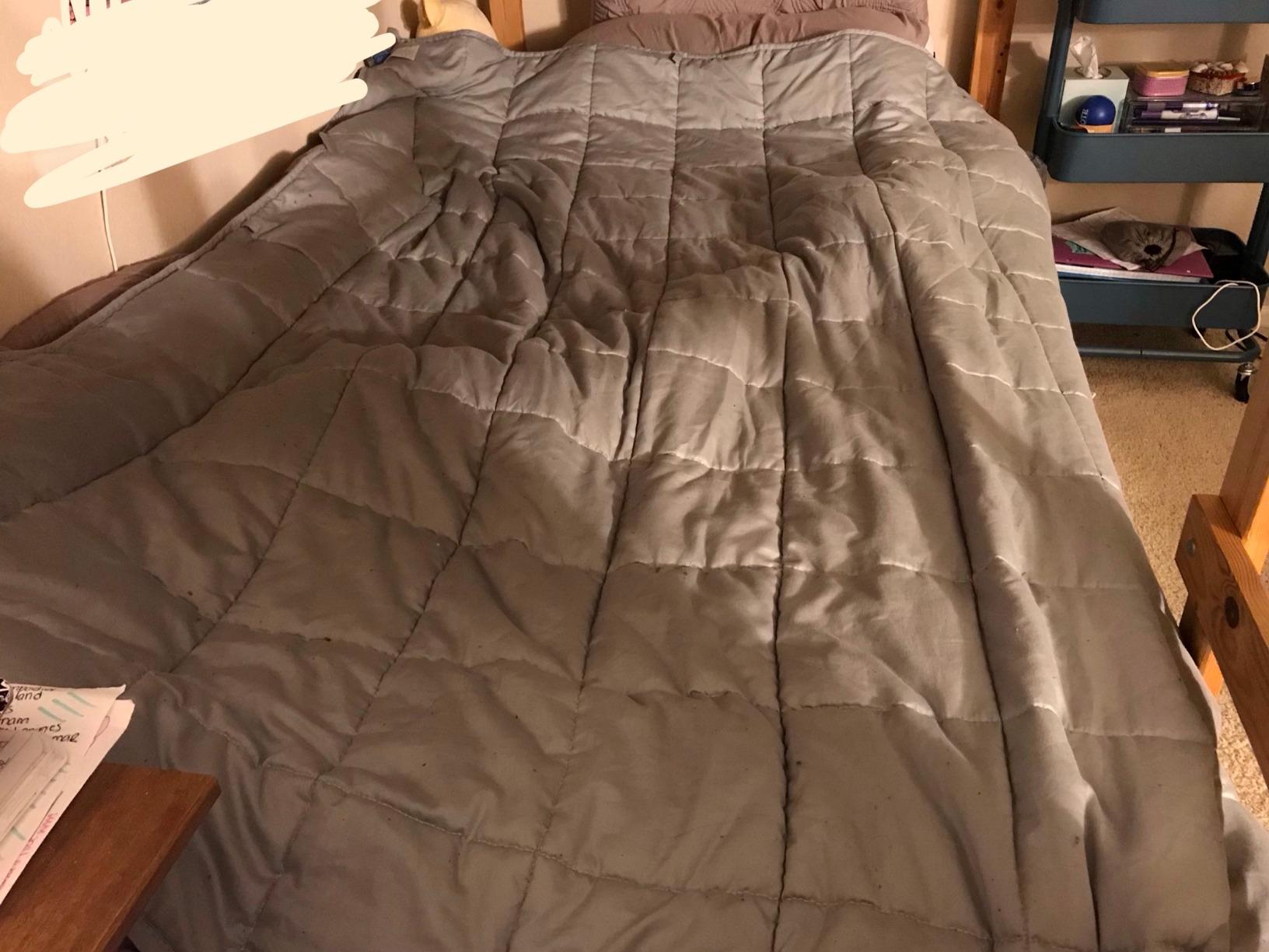 Close-up of Luna Weighted Blanket fabric texture showing the quilted grid stitching and soft cotton surface