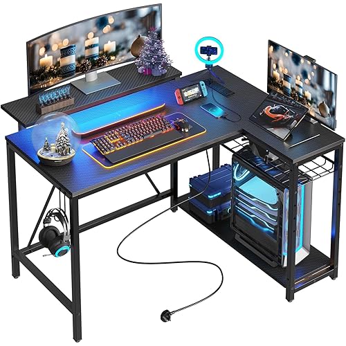 Bestier Gaming Desk with Power Outlets, 42" L-Shaped Computer Desk with LED Lights, Desk with Reversible Storage Shelves & Hooks for Small Spaces, Bedrooms & Offices, Black Carbon Fiber