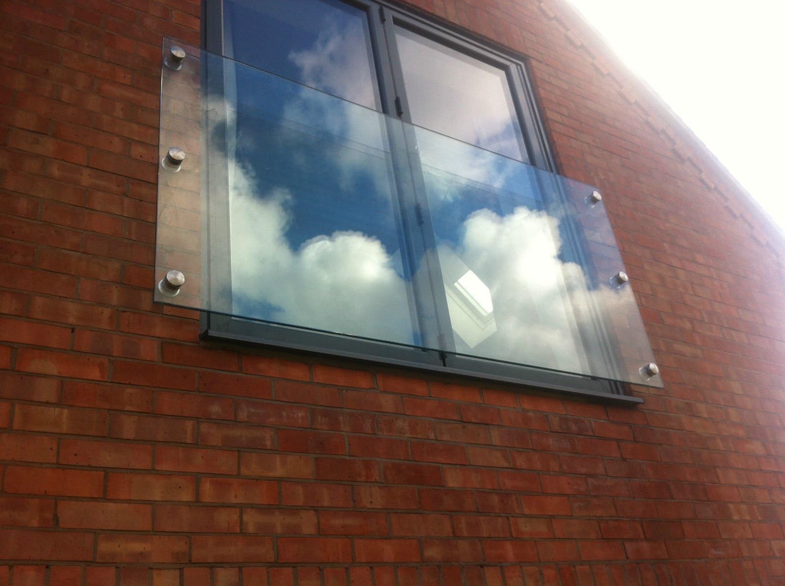 Toughened Glass Juliet Balcony 12mm Thick in Clear/Opti White Glass Complete With Round Stand off Fixing Brackets – Custom Made Glass Juliet Balcony Panels in Clear/Opti White Glass, Frosted Glass & Tinted Glass Finish Also Available