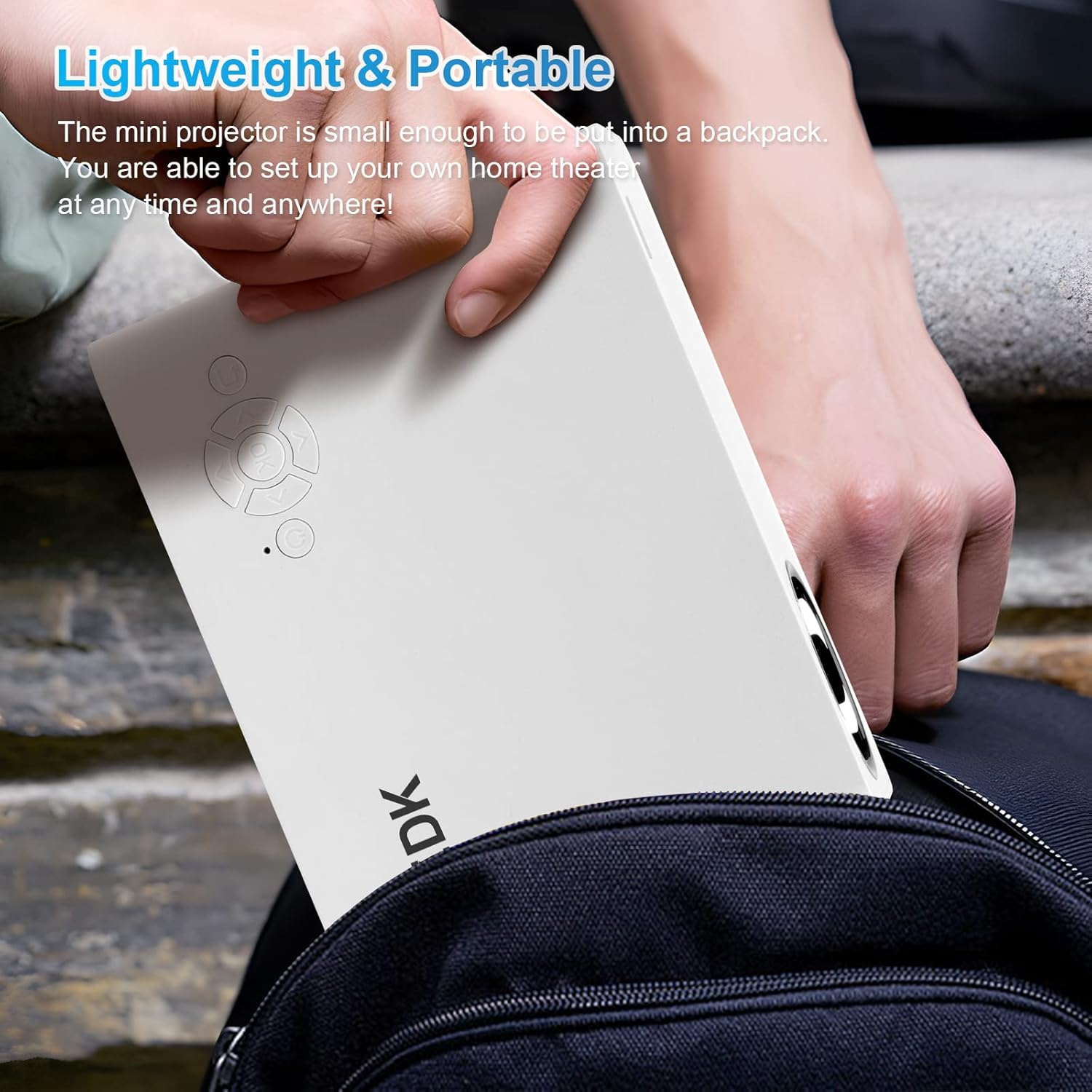 Image of the ZDK Mini Projector being placed into a backpack, highlighting its lightweight and portable design.
