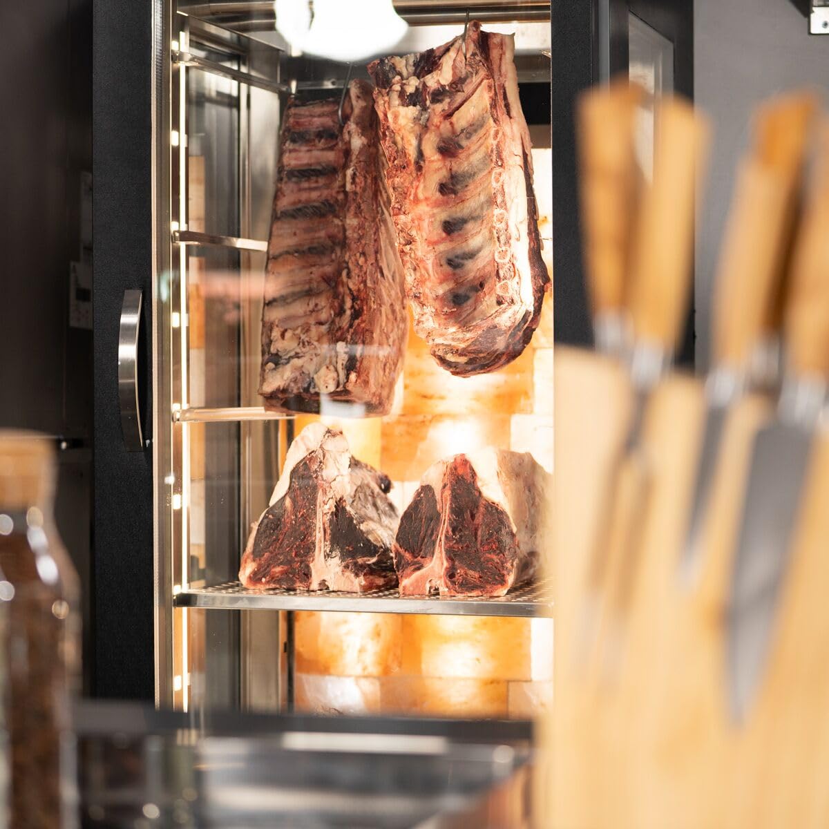 Interior of GGM Gastro Dry Aging Cabinet with meat hanging and on shelves