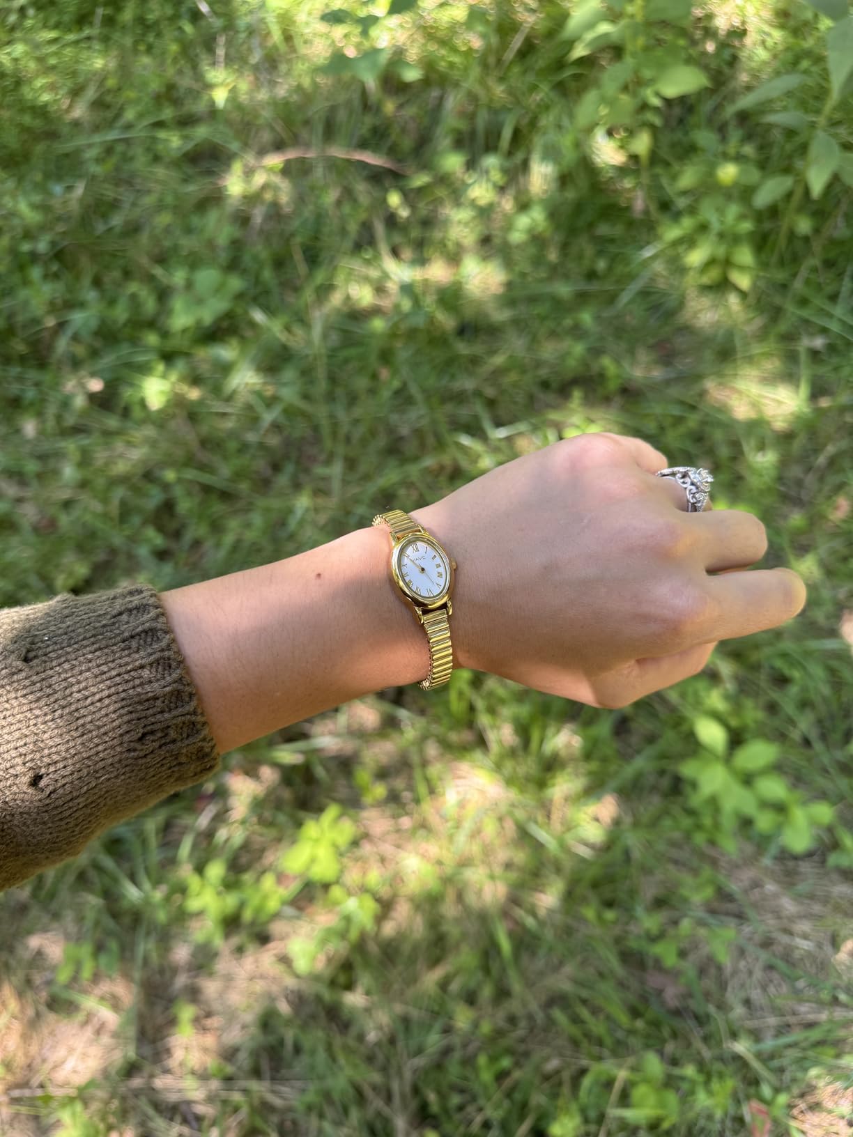 Minimalist gold bangle watch styled for office outfits