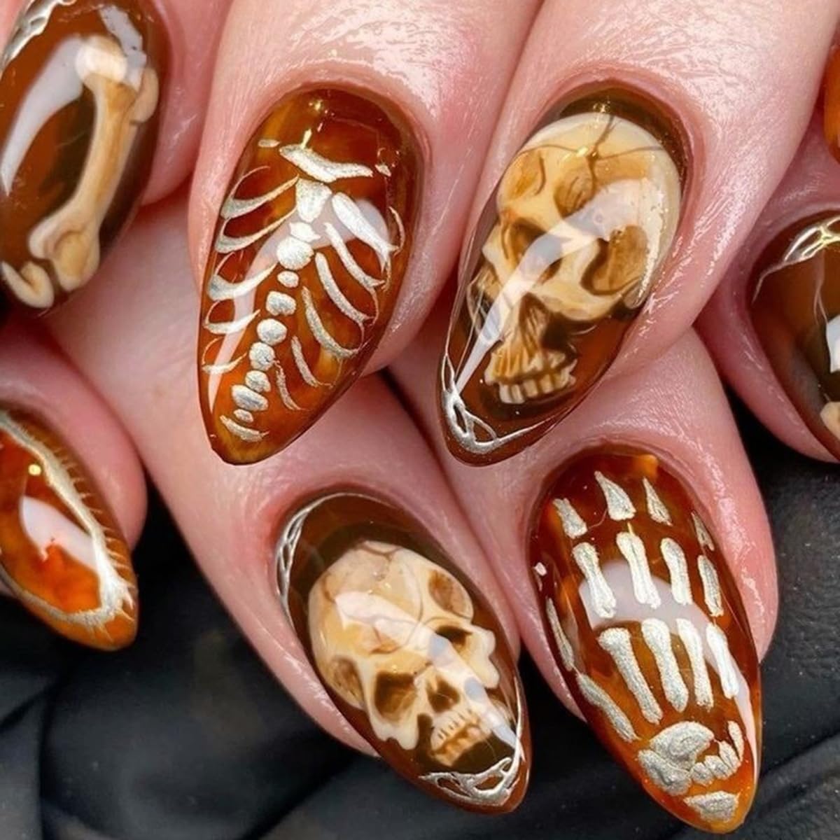 24Pcs Halloween Press on Nails Short Almond QUNQINLI Fake Nails with Bone Skull Designs Orange False Nails Golden Hollow Stick on Nails Glossy Acrylic