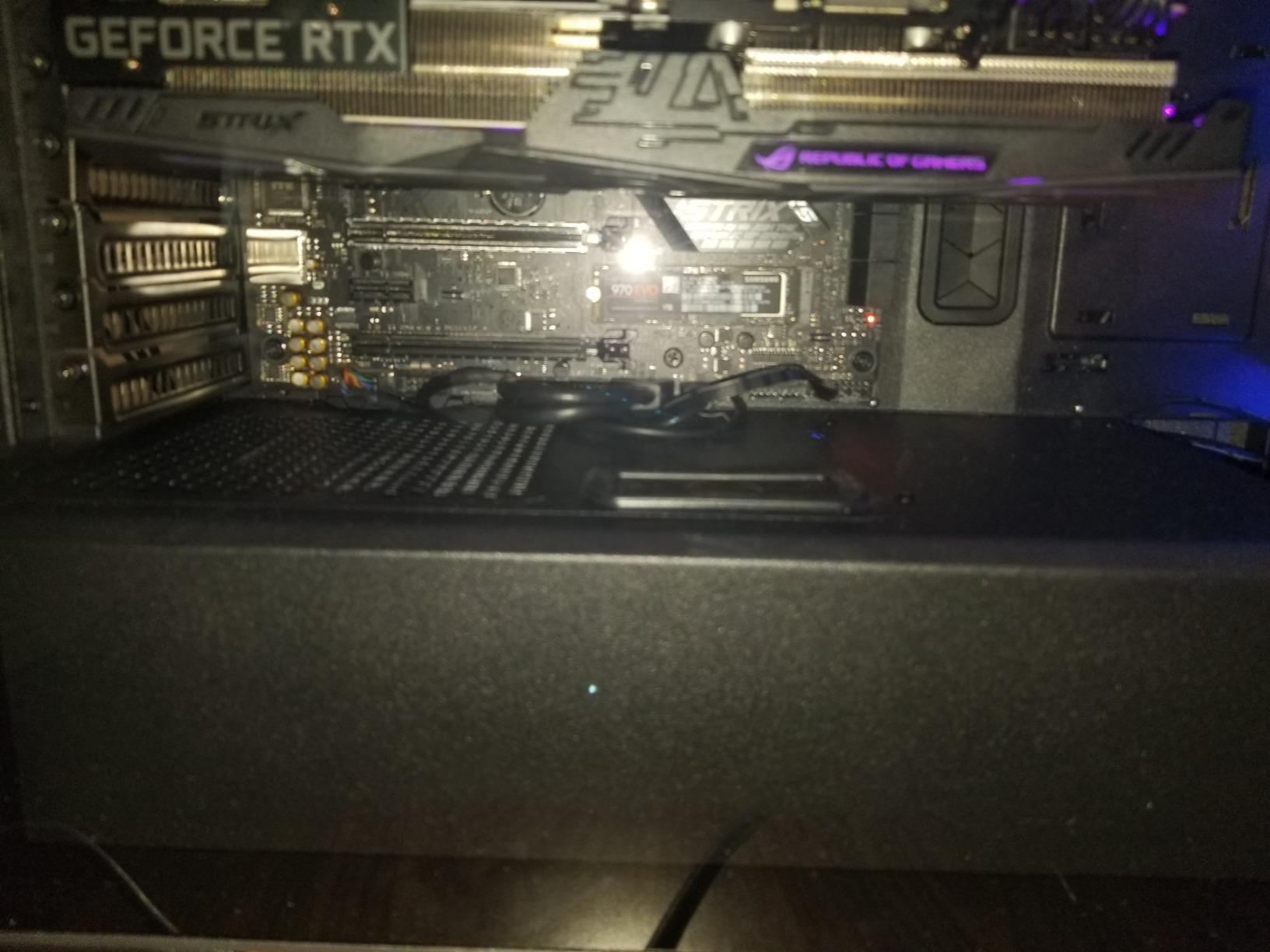 Internal view of a PC build in the Cooler Master MasterBox MB530P, showing a top-mounted radiator and RGB components.