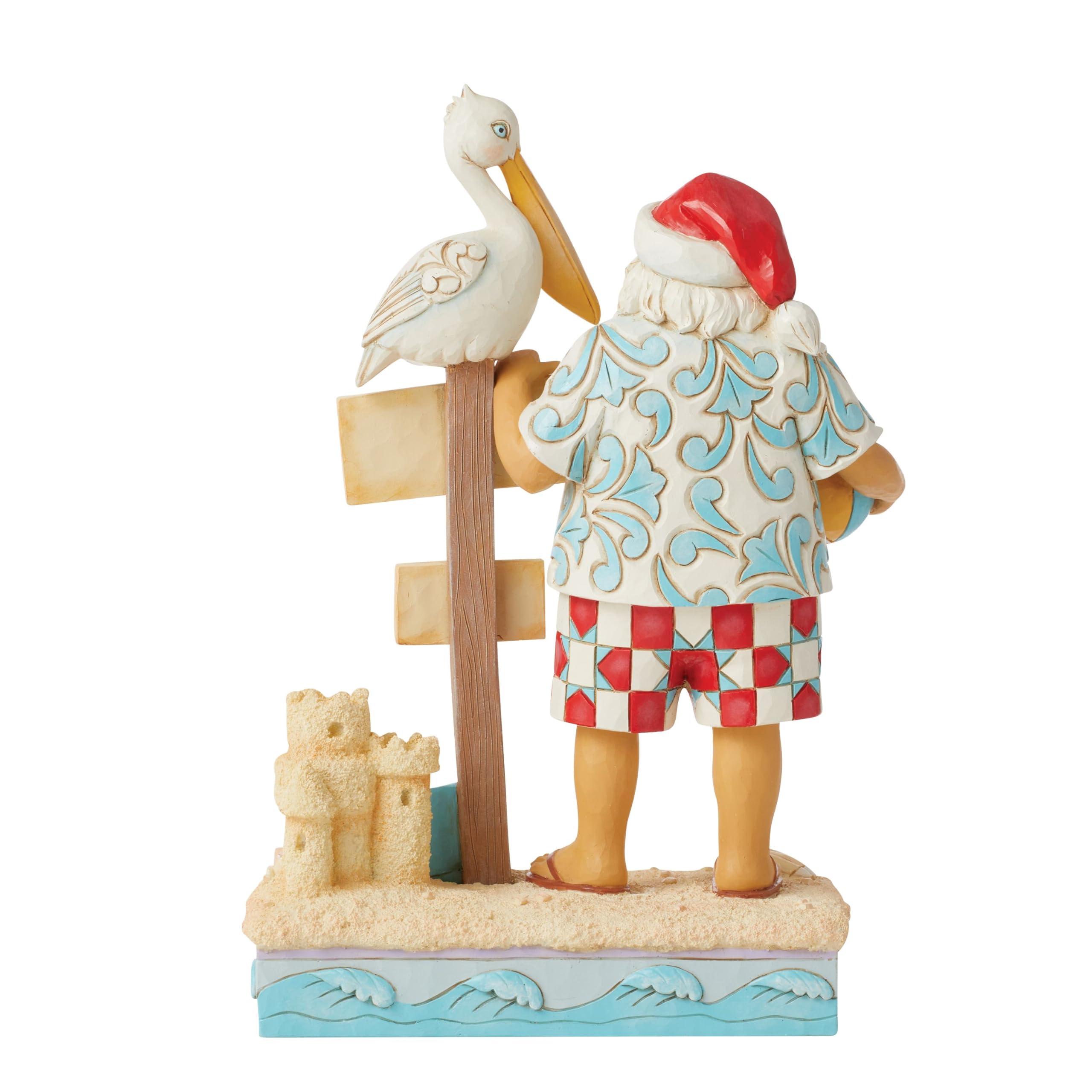 Enesco Jim Shore Heartwood Creek Figurine de Père Noël côtier avec panneaux de plage et pélican - Pierre en résine peinte à la main - Figurine de Père Noël de collection - Décoration d'intérieur - 24