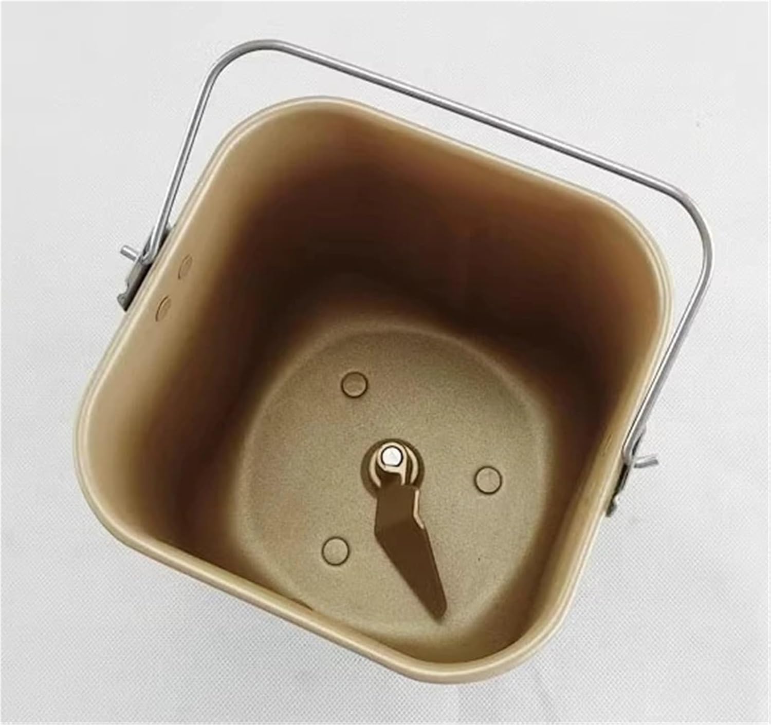 വശം view of the bread machine mixing bucket interior, showing the smooth non-stick surface