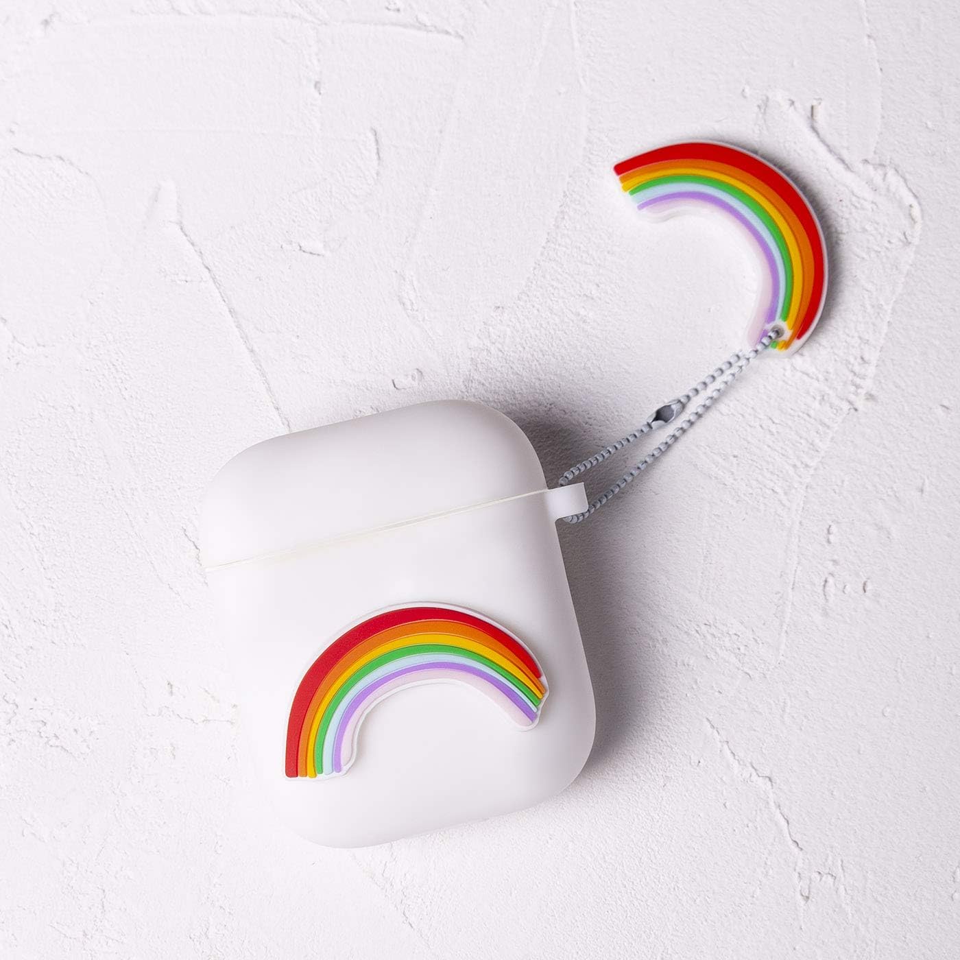 White silicone case for Airpods 1 & 2 with 3D piece of colorful rainbows, design by Lucía Be, Medio